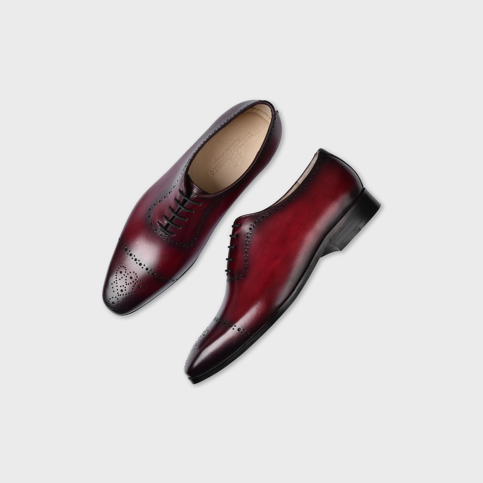 Pair of Lonzo Wine Lace Ups, burgundy leather oxford dress shoes with broguing detail.