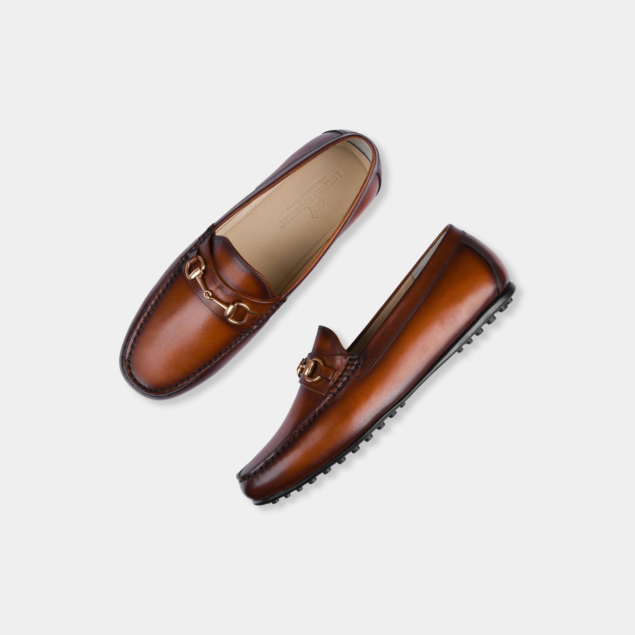 Pair of Marco Tan Leather Driving Loafers with gold snaffle bit detail, shown from above on a white background.