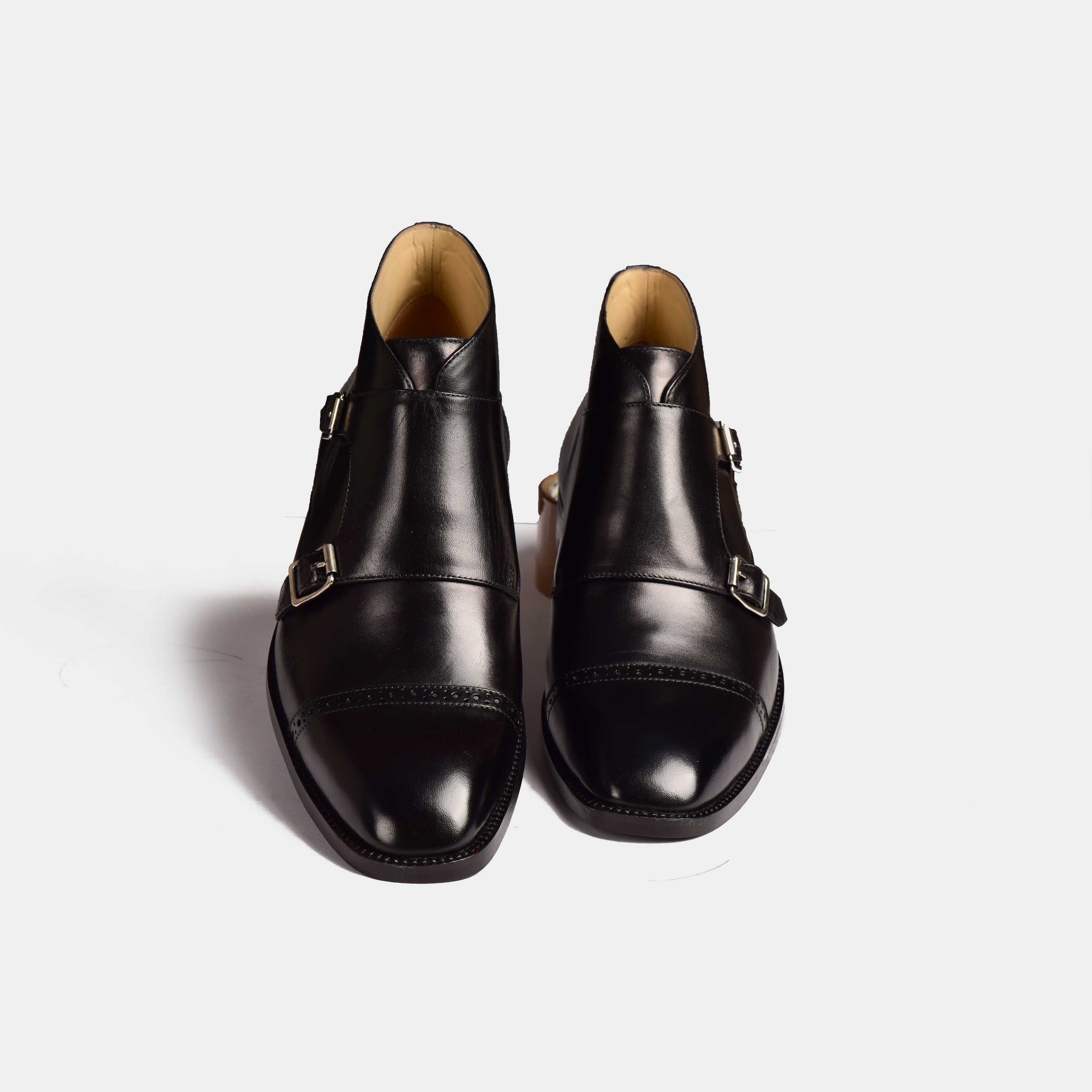 Pair of Alfred Double Monk Boots in black leather, showcasing the double monk strap design.