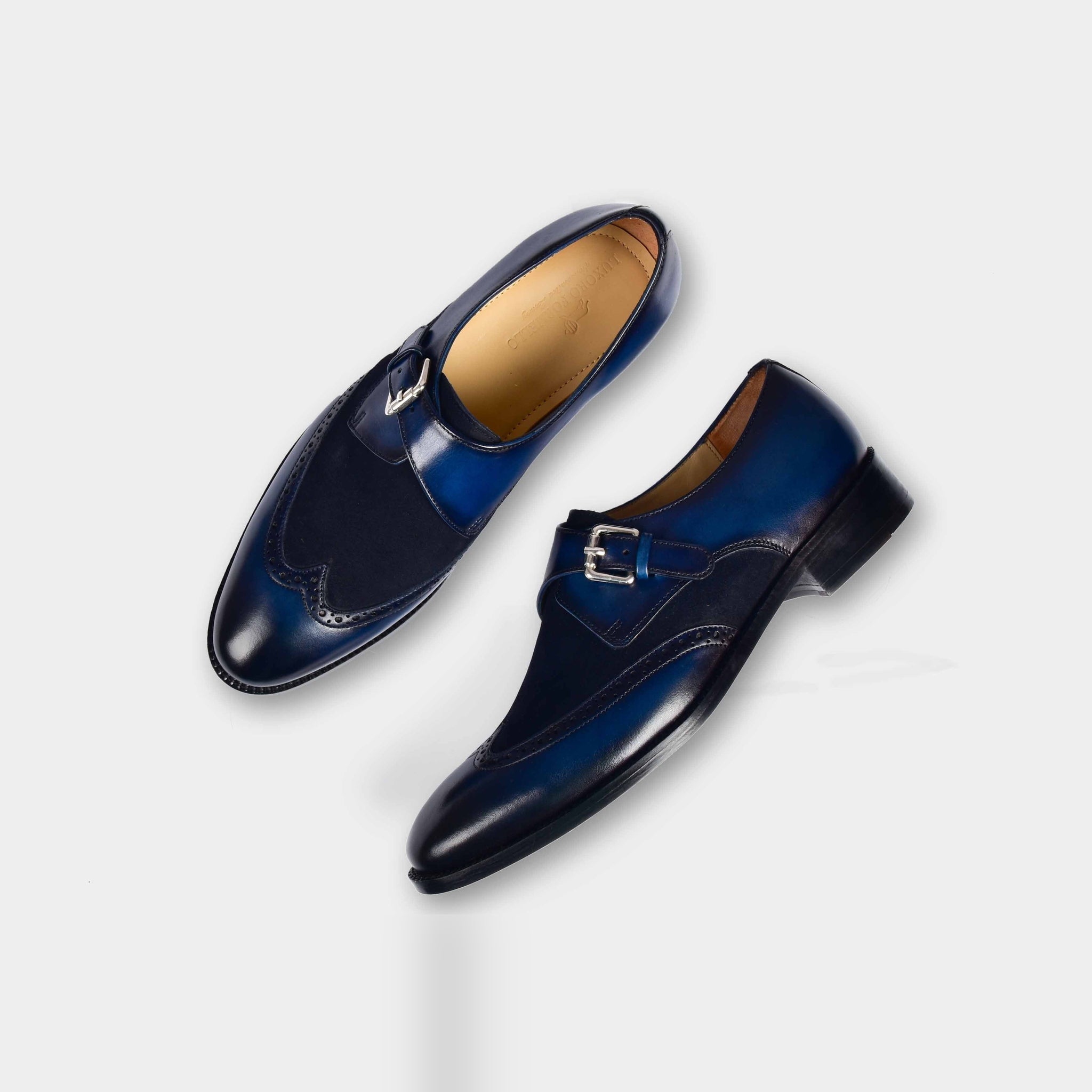 Pair of Bruce Blue Single Leather Monk Strap shoes with brogue detailing and a navy blue suede insert.