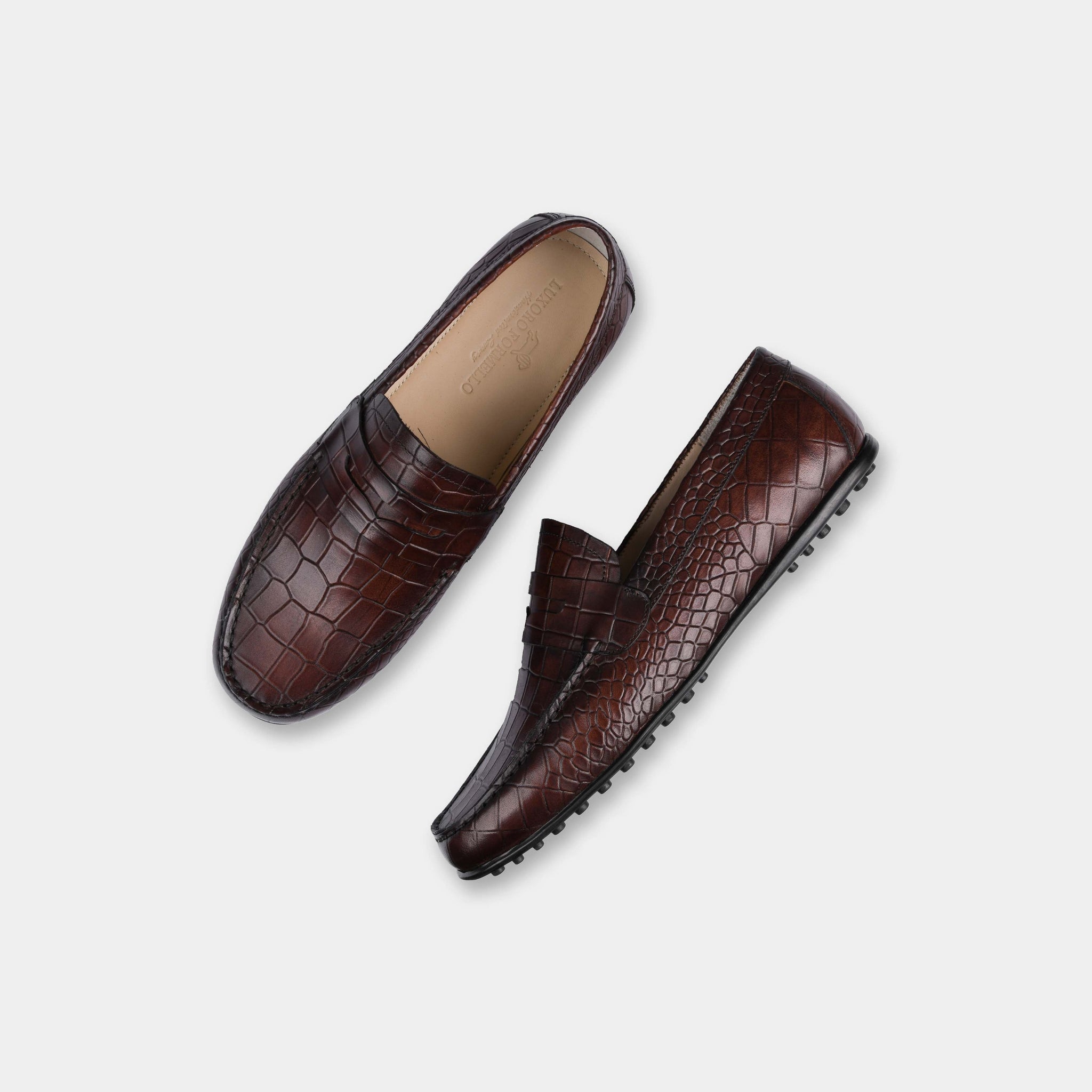 Pair of Camila Brown Leather Driving Loafers, featuring a stylish crocodile-embossed pattern, shown from above.