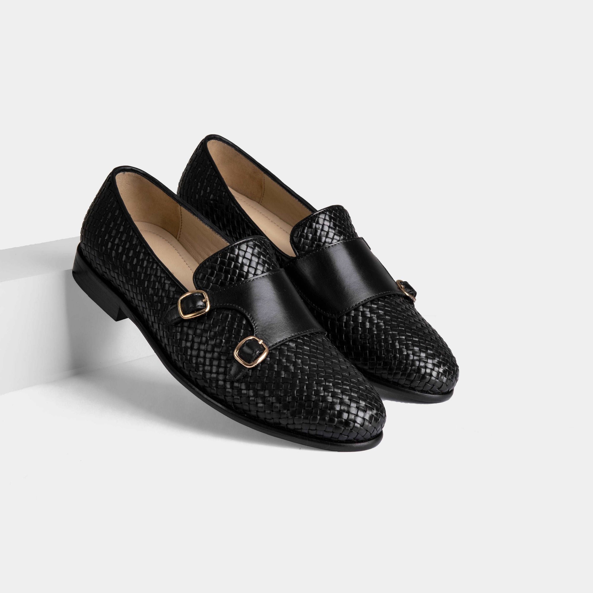 Pair of Ciro Weaved Black Leather Monk Straps with a woven leather upper and double buckle closure.