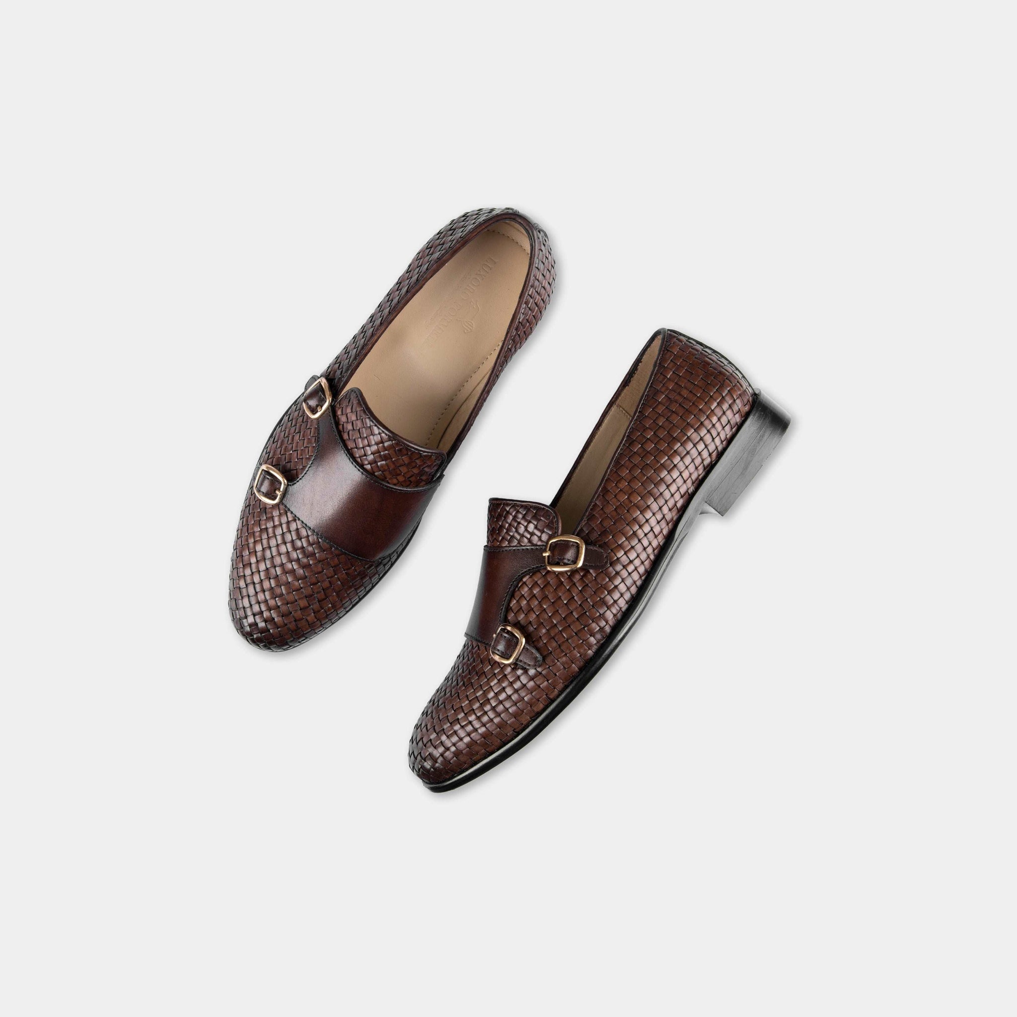 Pair of Ciro Weaved brown leather monk strap shoes with woven detail and double gold buckles, shown from above.