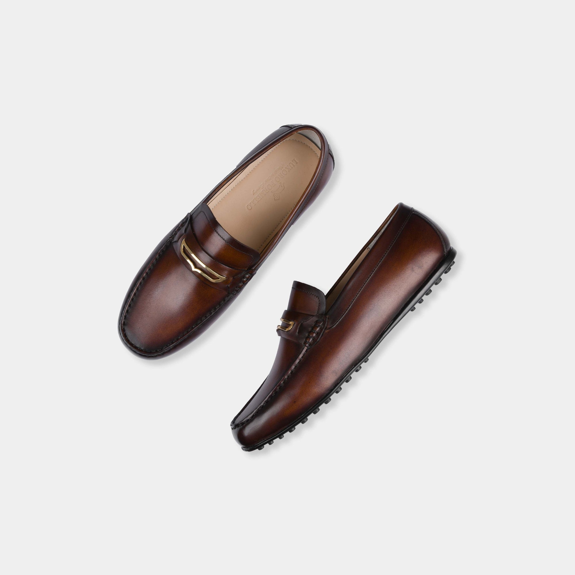 Pair of Cruz Brown Leather Driving Loafers with a gold buckle accent.