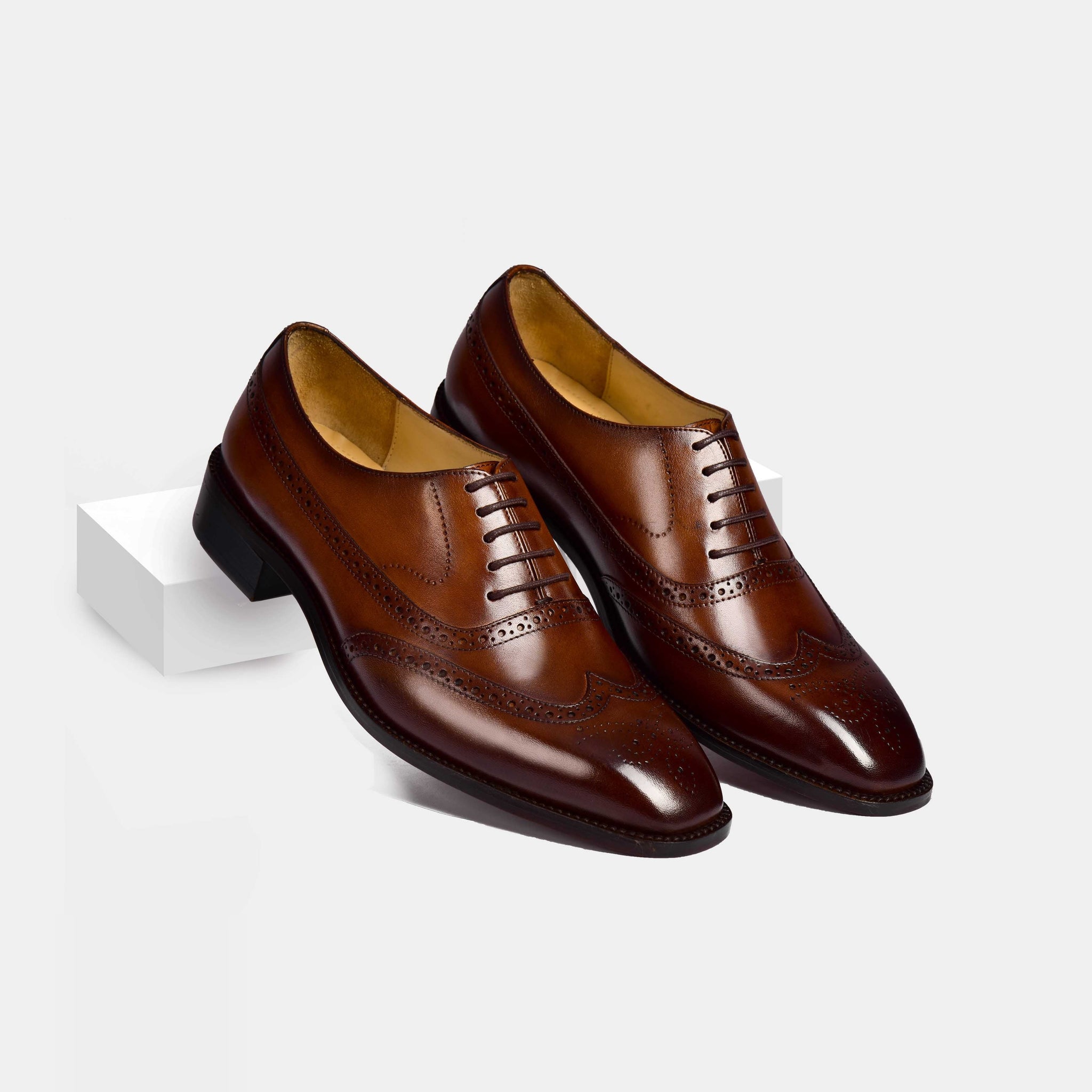 Pair of Melvin Litt Leather Laceups, brown wingtip dress shoes, shown on a white background.