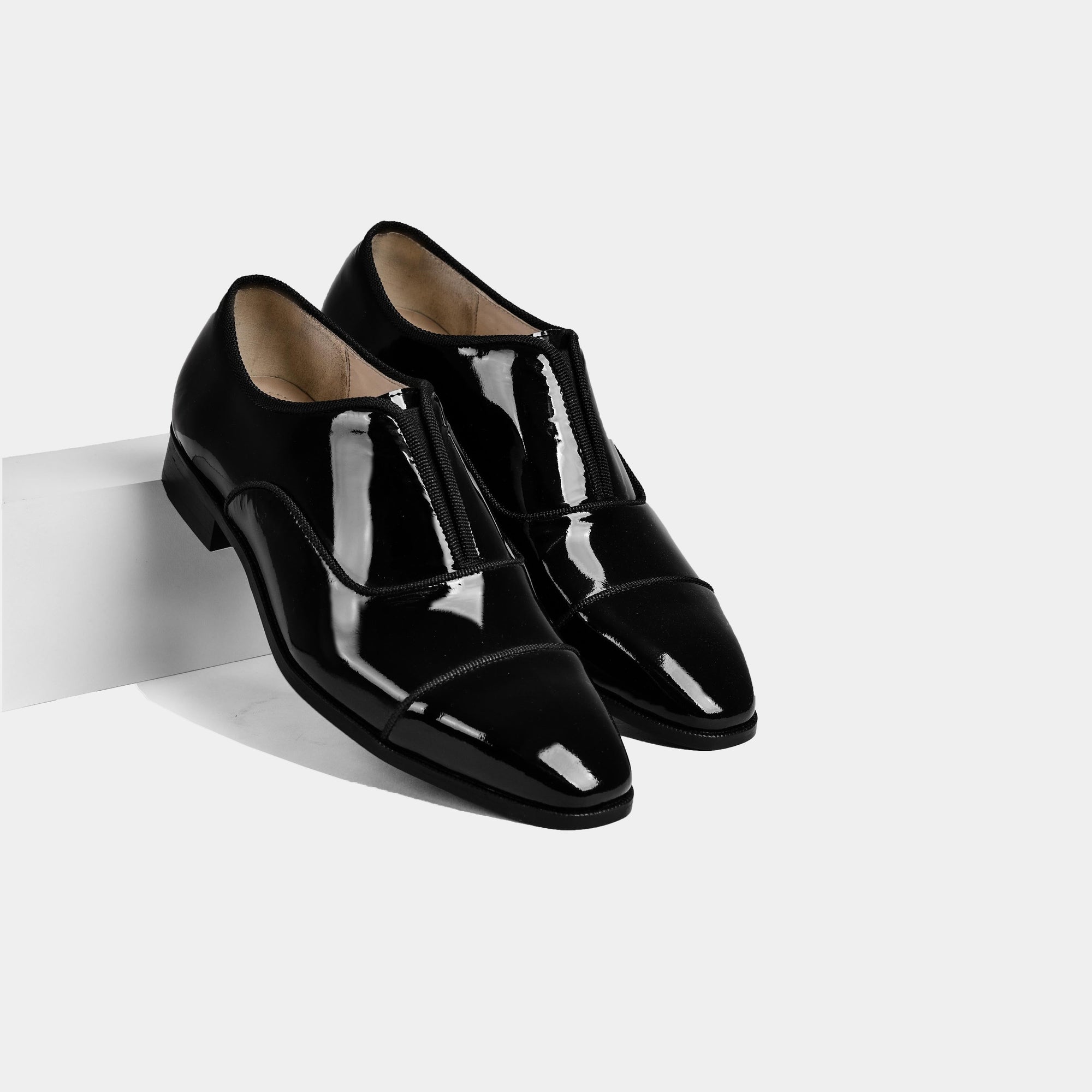 Pair of Luix Patent Leather Loafers in black, showcasing their sleek design and glossy finish.