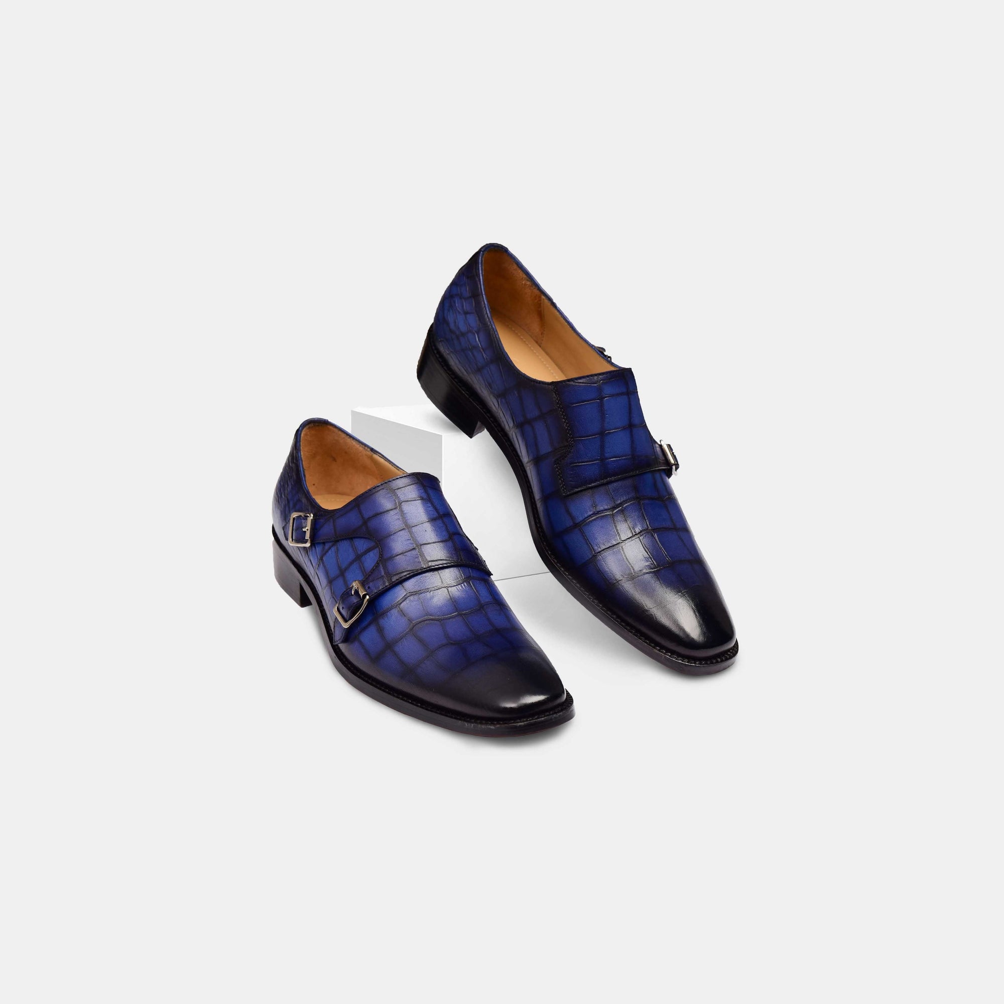 Pair of blue Michael Niel Leather Monk Straps, showcasing the stylish double buckle closure and crocodile-embossed leather.