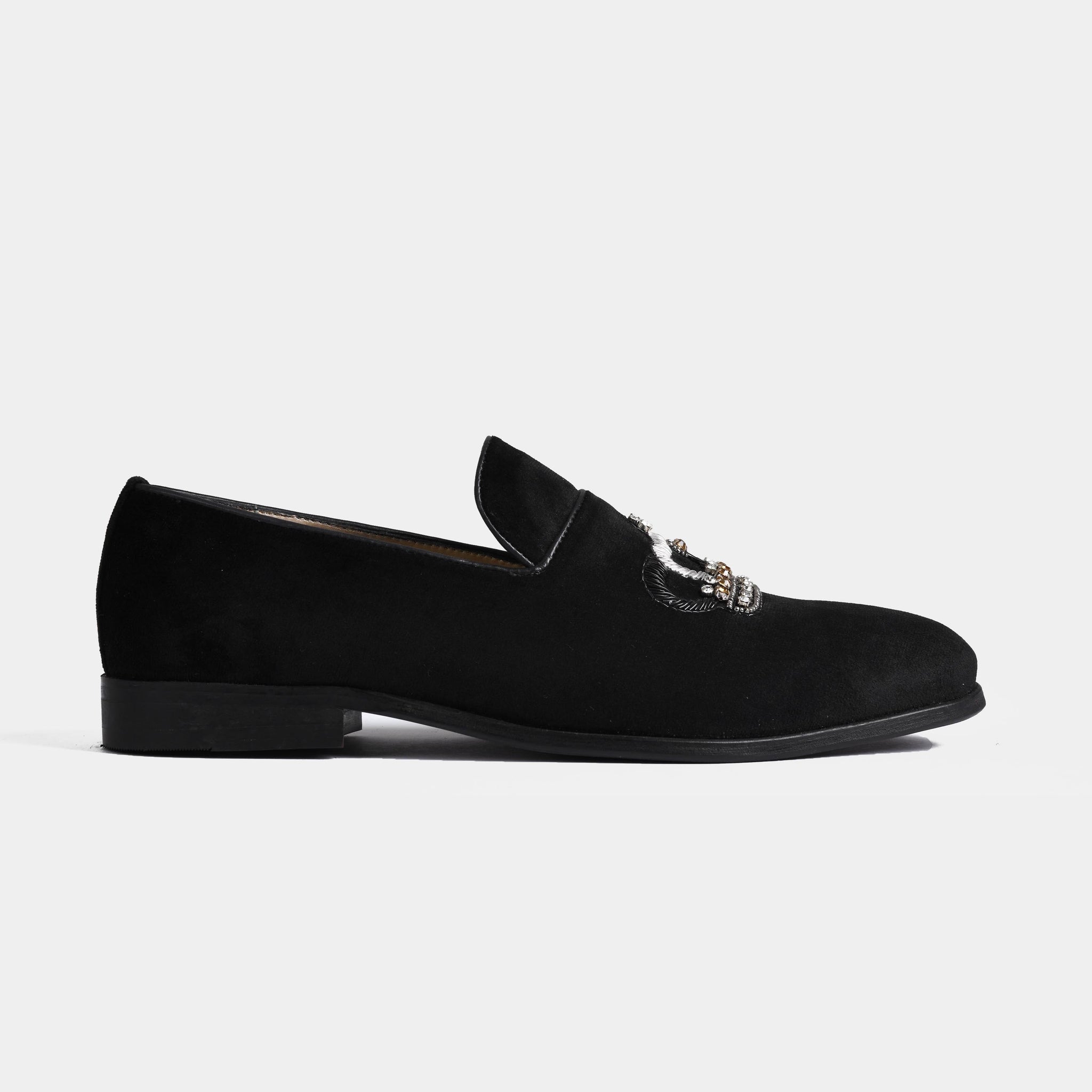 Side view of a pair of Luciano Black Embroidered Leather Slip-Ons with intricate black and silver embroidery on the vamp.