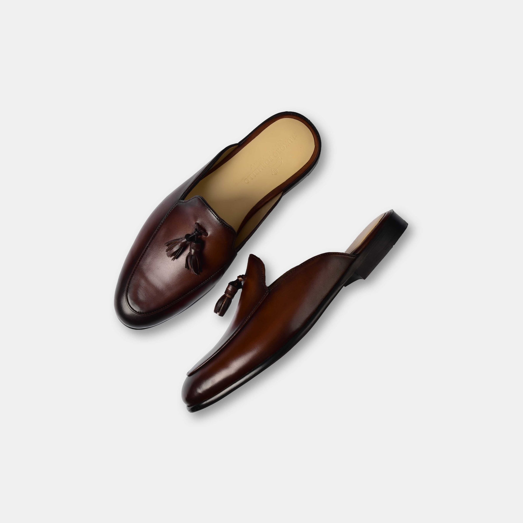 Pair of Arno brown leather formal mules with tassels, shown from above.