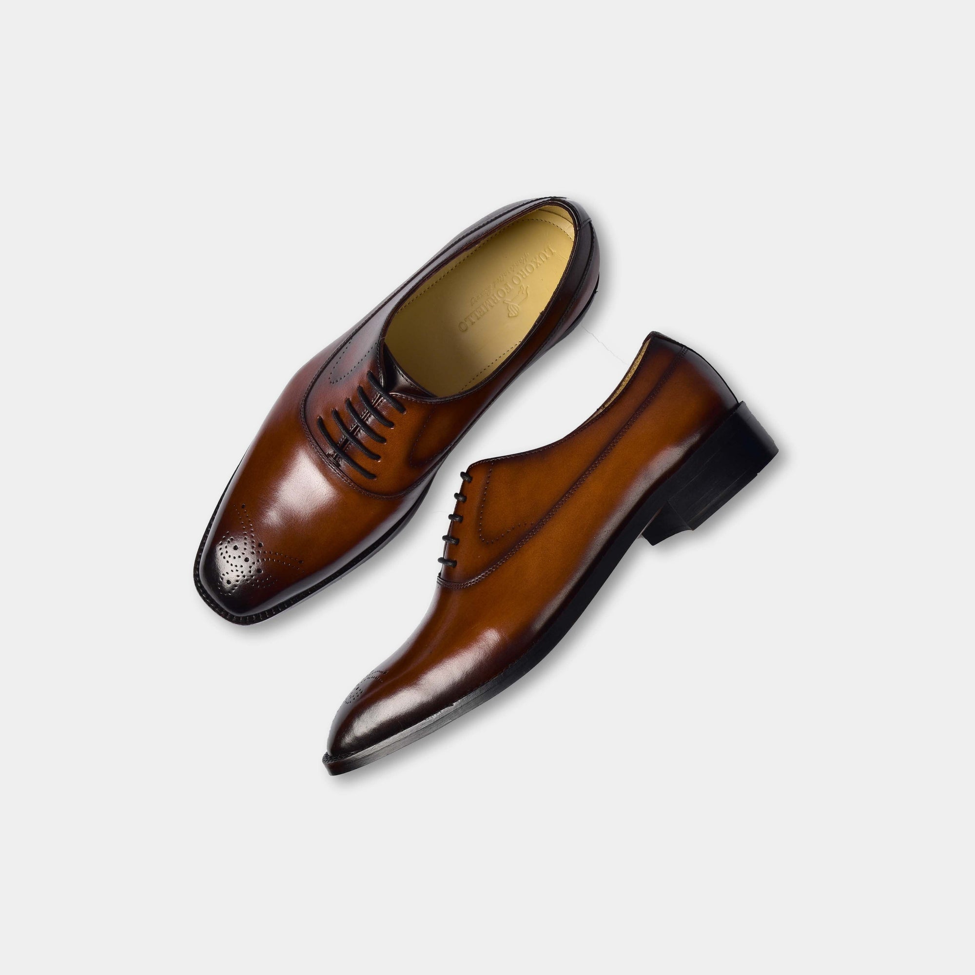 Pair of Peter Gomez Leather Laceups in brown, showcasing their stylish brogue detailing and classic lace-up design.