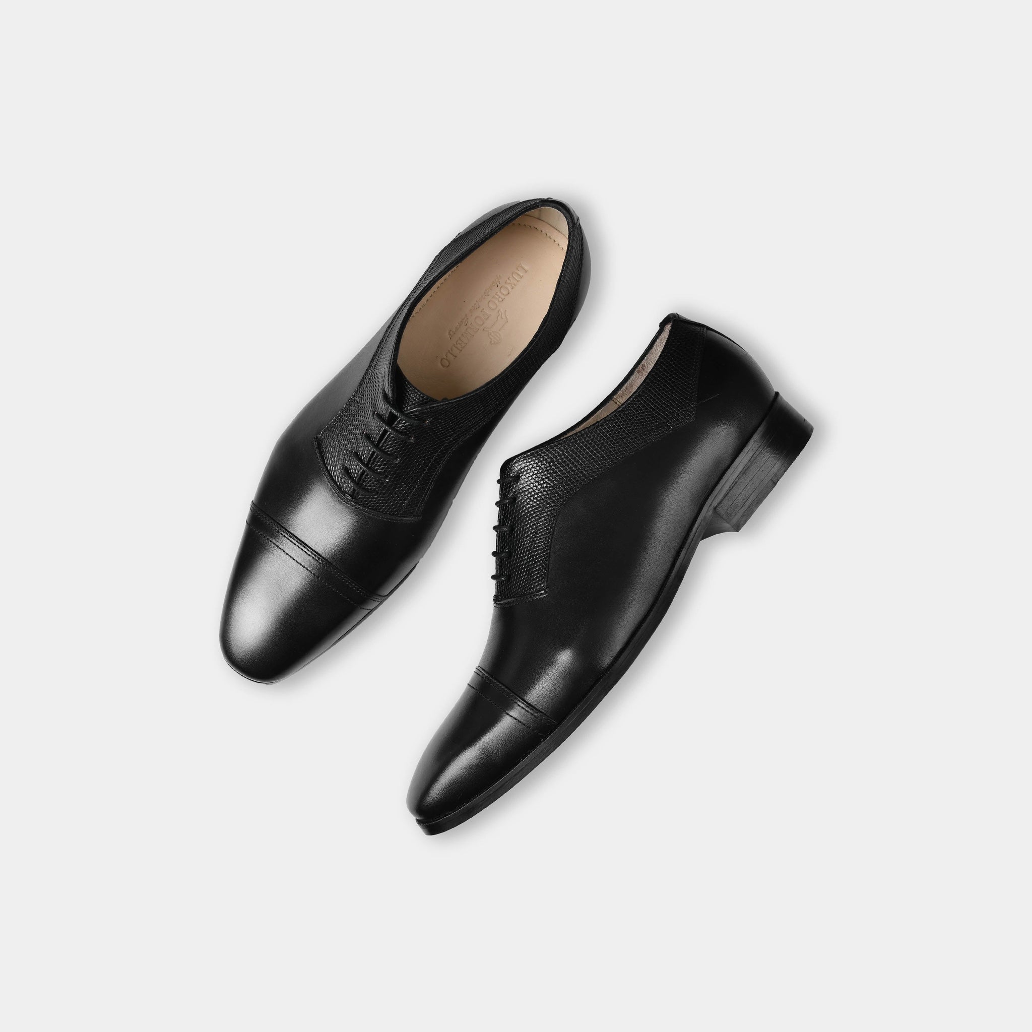 Pair of Elvio black leather lace-up dress shoes with perforated detailing, shown from above.