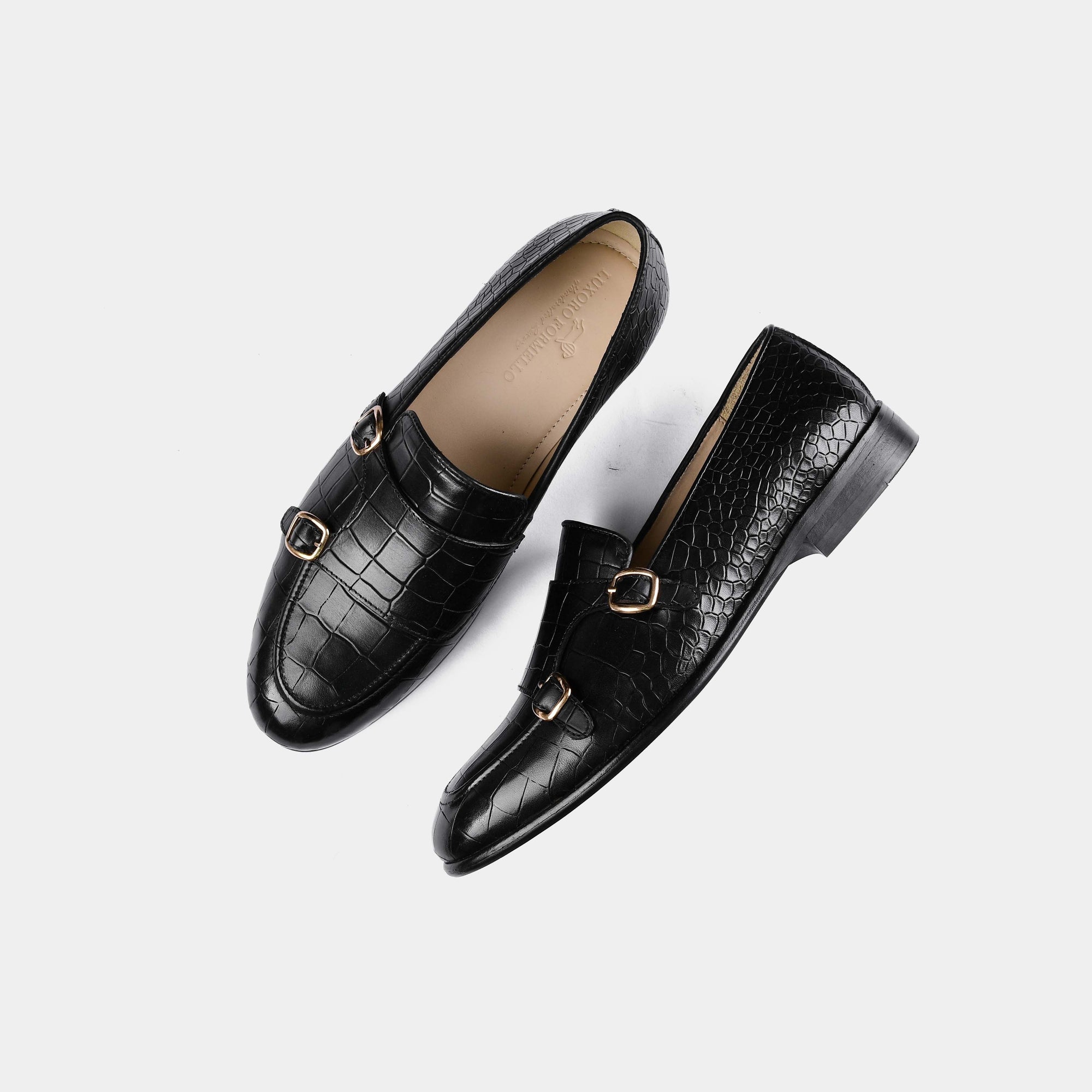 Pair of Valeria Croc Black Leather Monk Straps shoes with gold buckles on a white background.