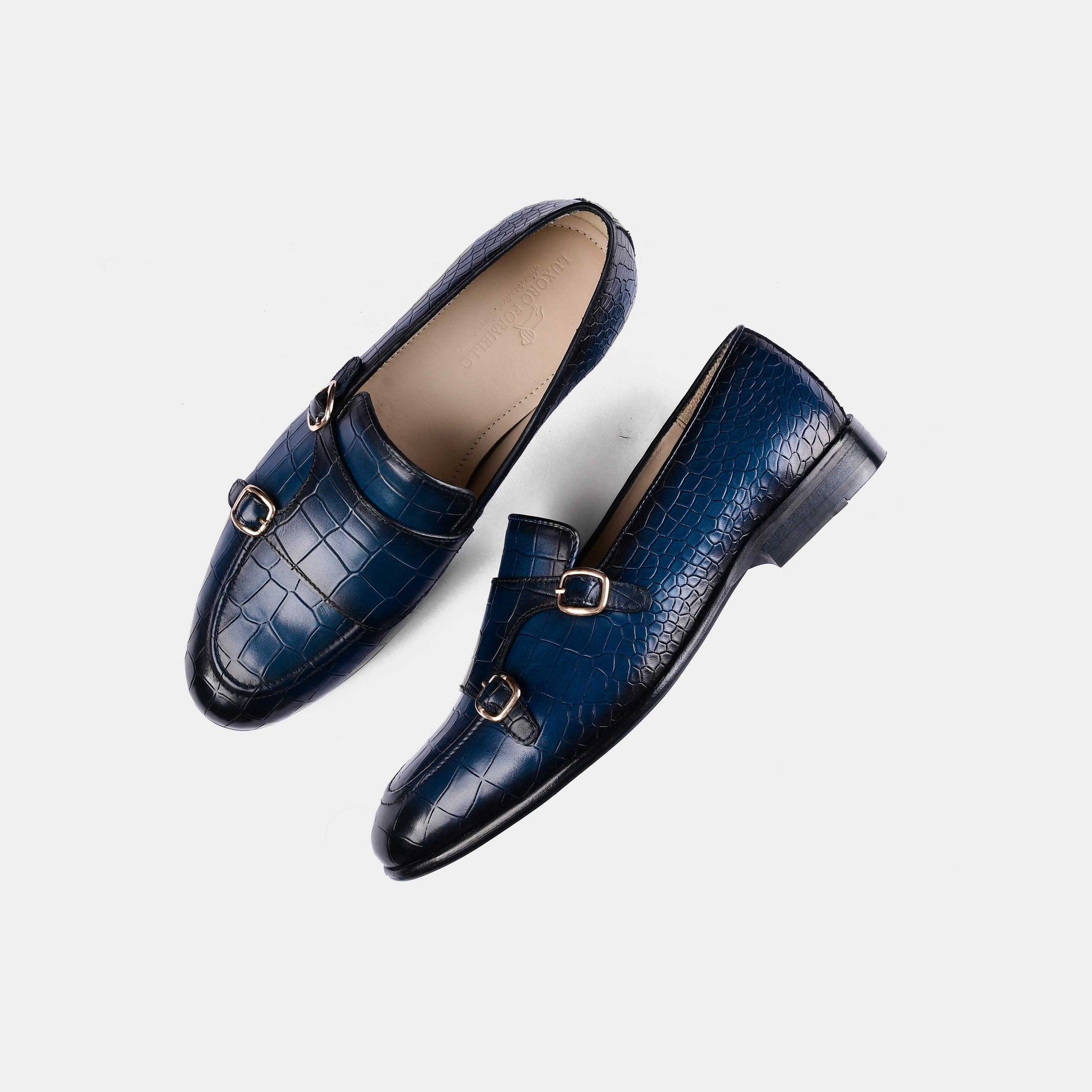 Pair of Valeria Croc Blue Leather Monk Strap shoes in blue crocodile-embossed leather with double buckle closures.