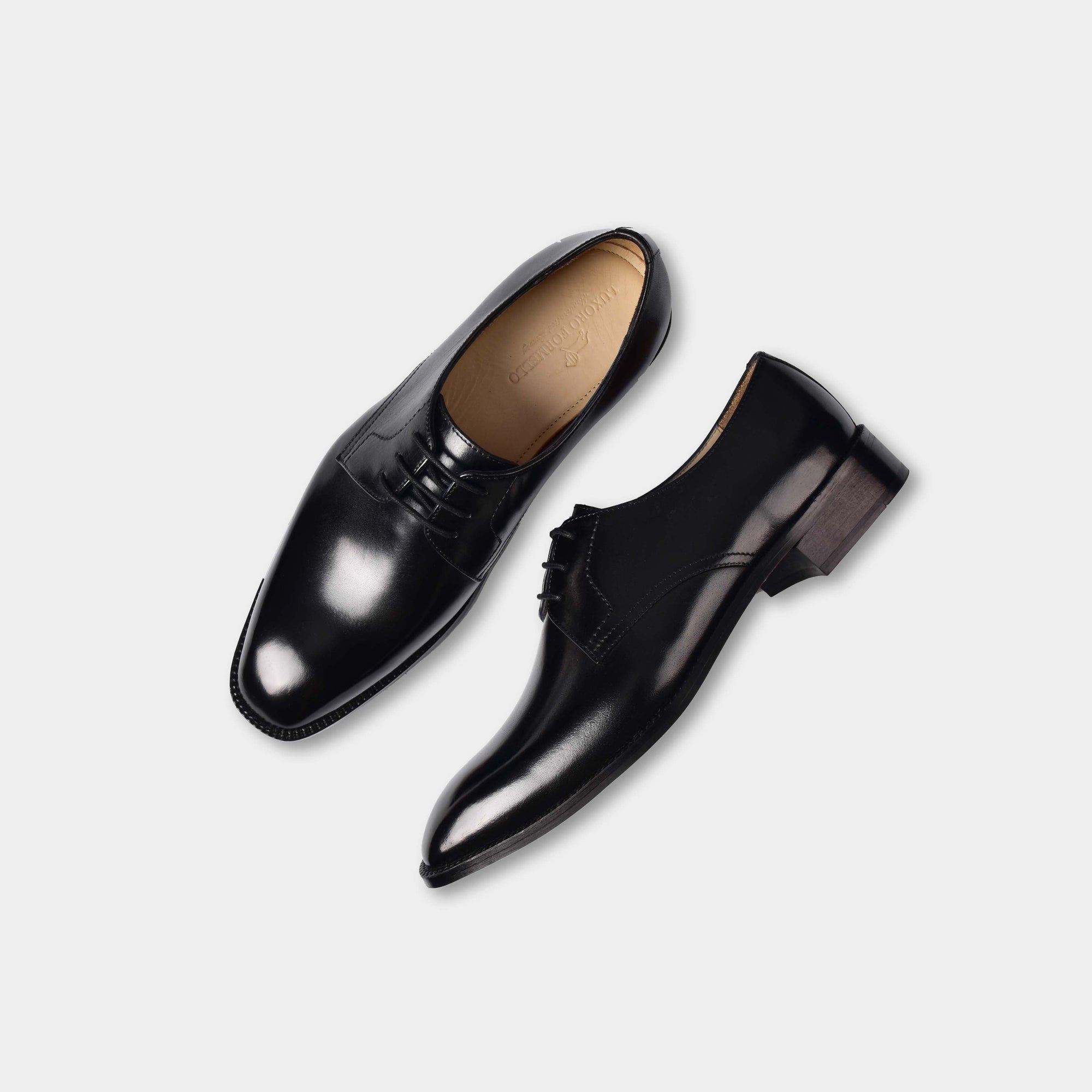 A pair of Reuben Lincoln Leather Laceups in black, showcasing their sleek design and polished leather finish.