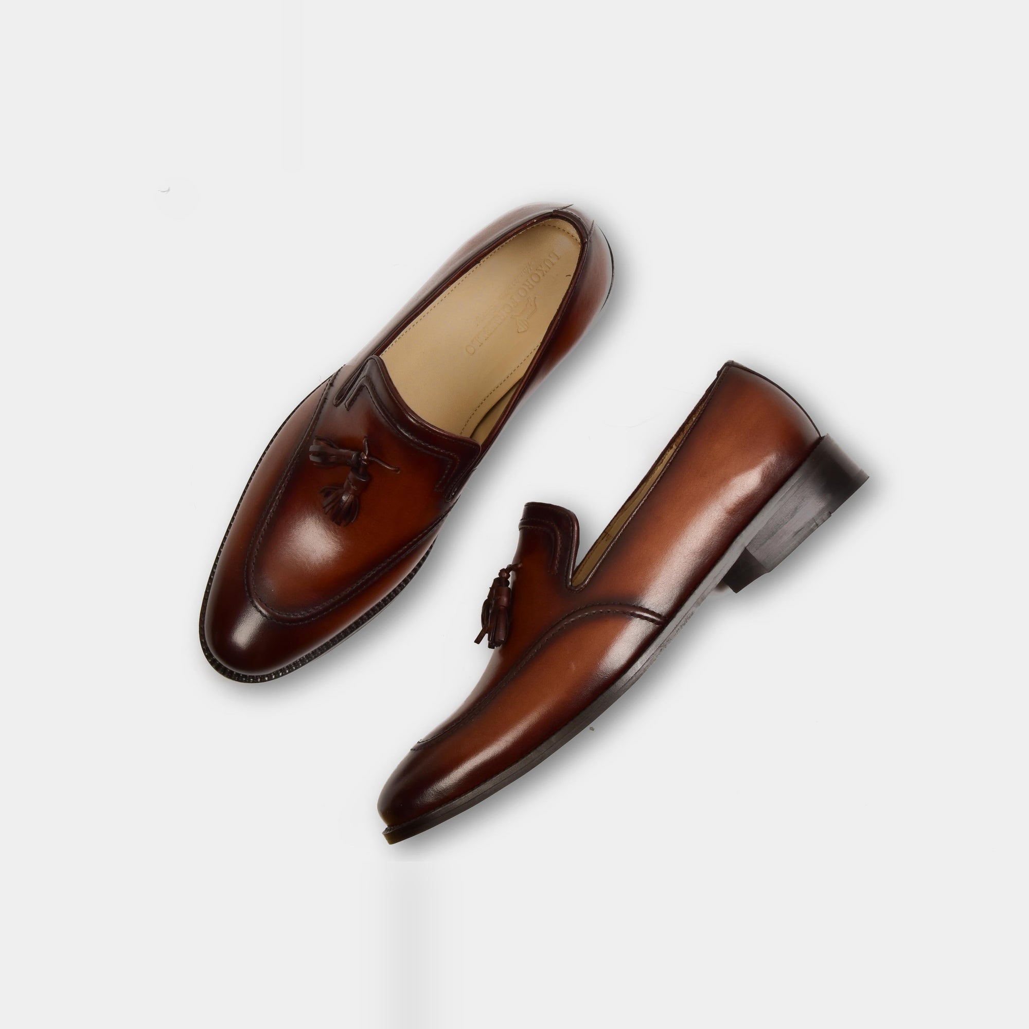 Pair of Jim Taylor Leather Loafers in brown, showcasing their tassel detail and polished finish.