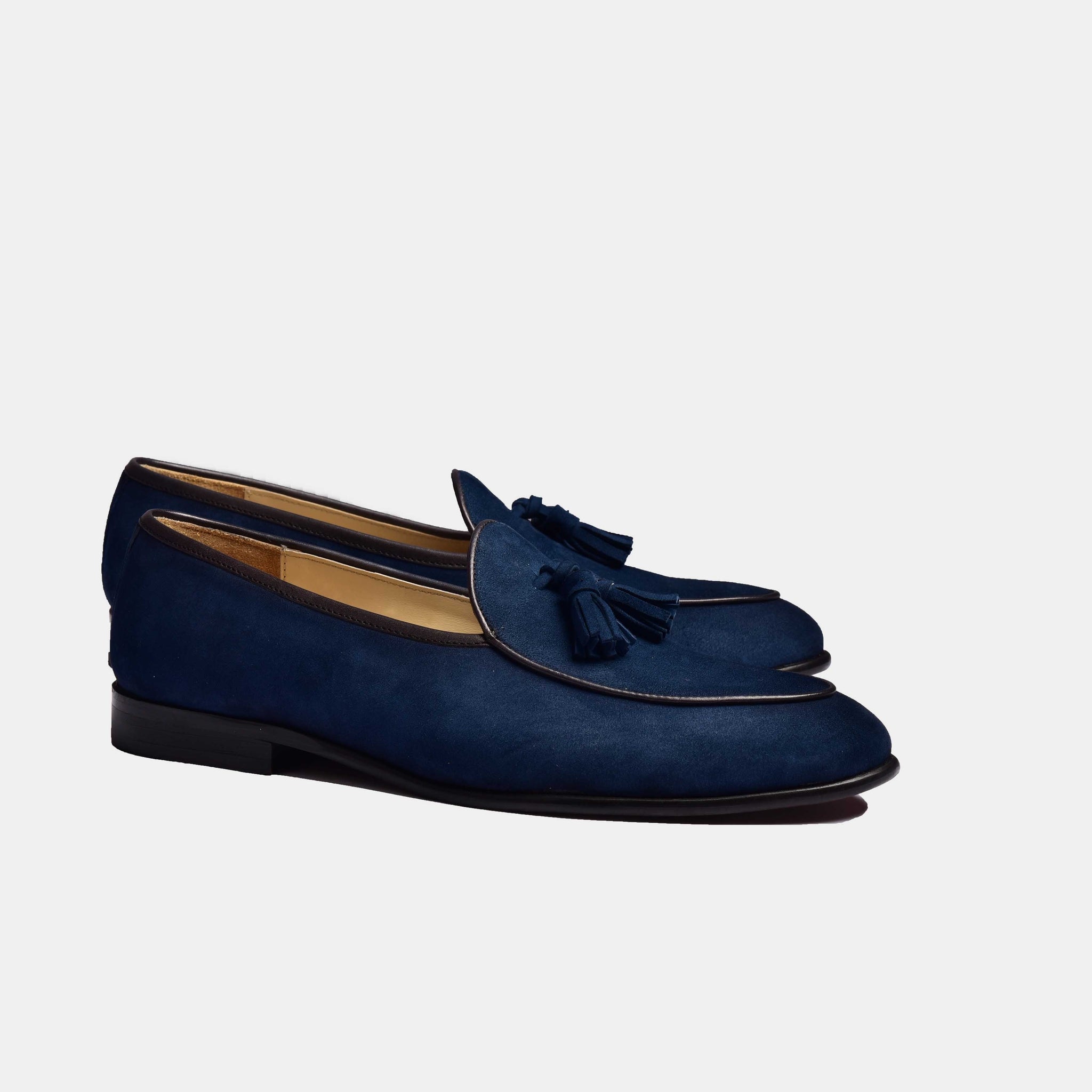 A pair of Arno Loafers in navy blue suede with classic tassels.