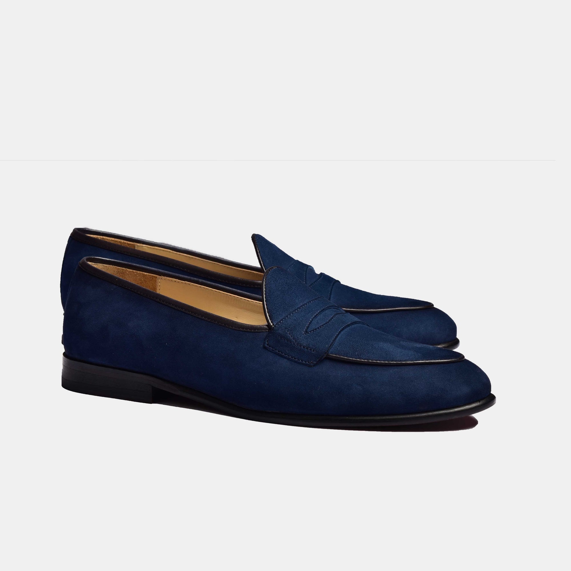 A pair of navy blue suede Arno loafers with a classic grand penny loafer design.