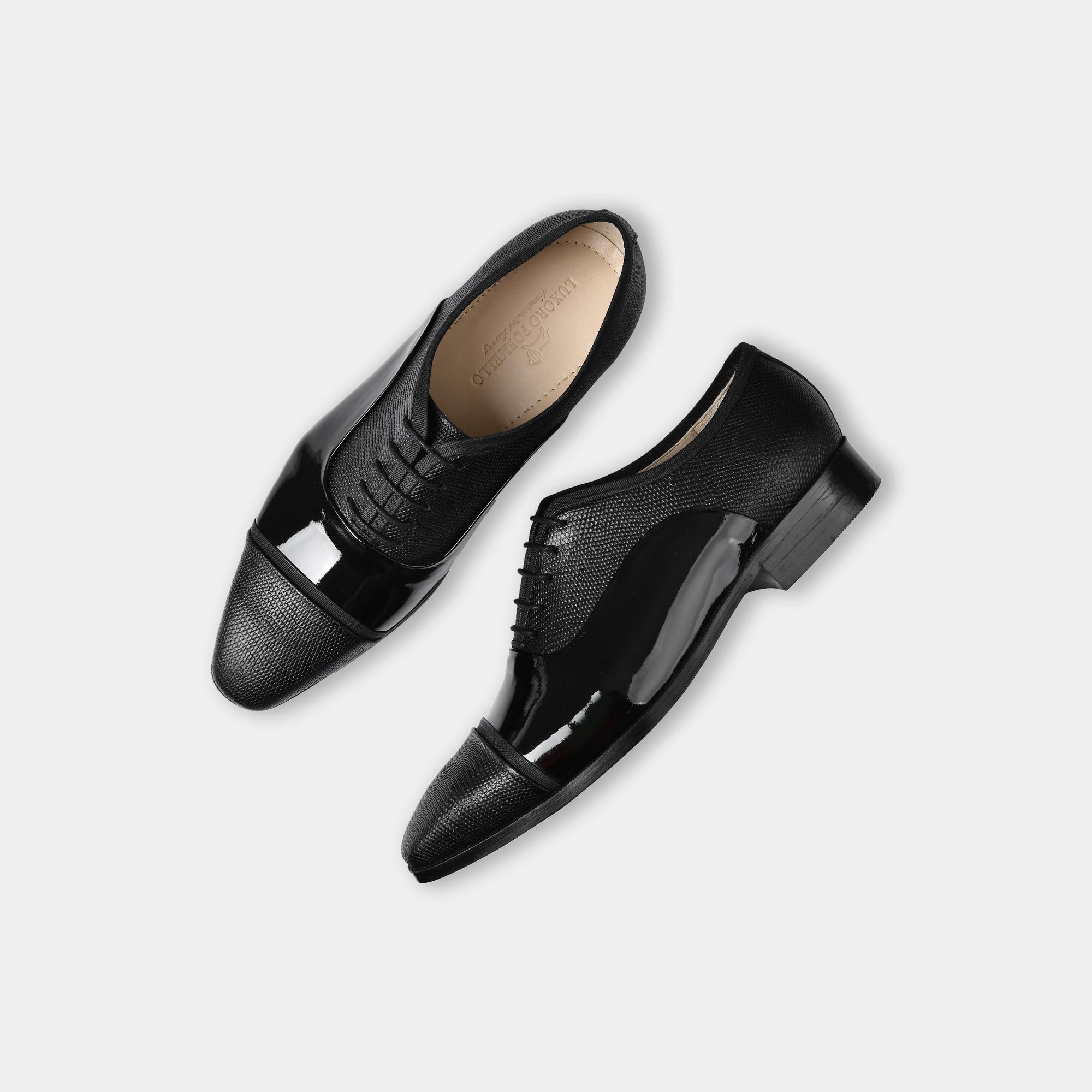 Pair of Ambros Patent black leather lace-up shoes with a textured toe cap and shiny finish.