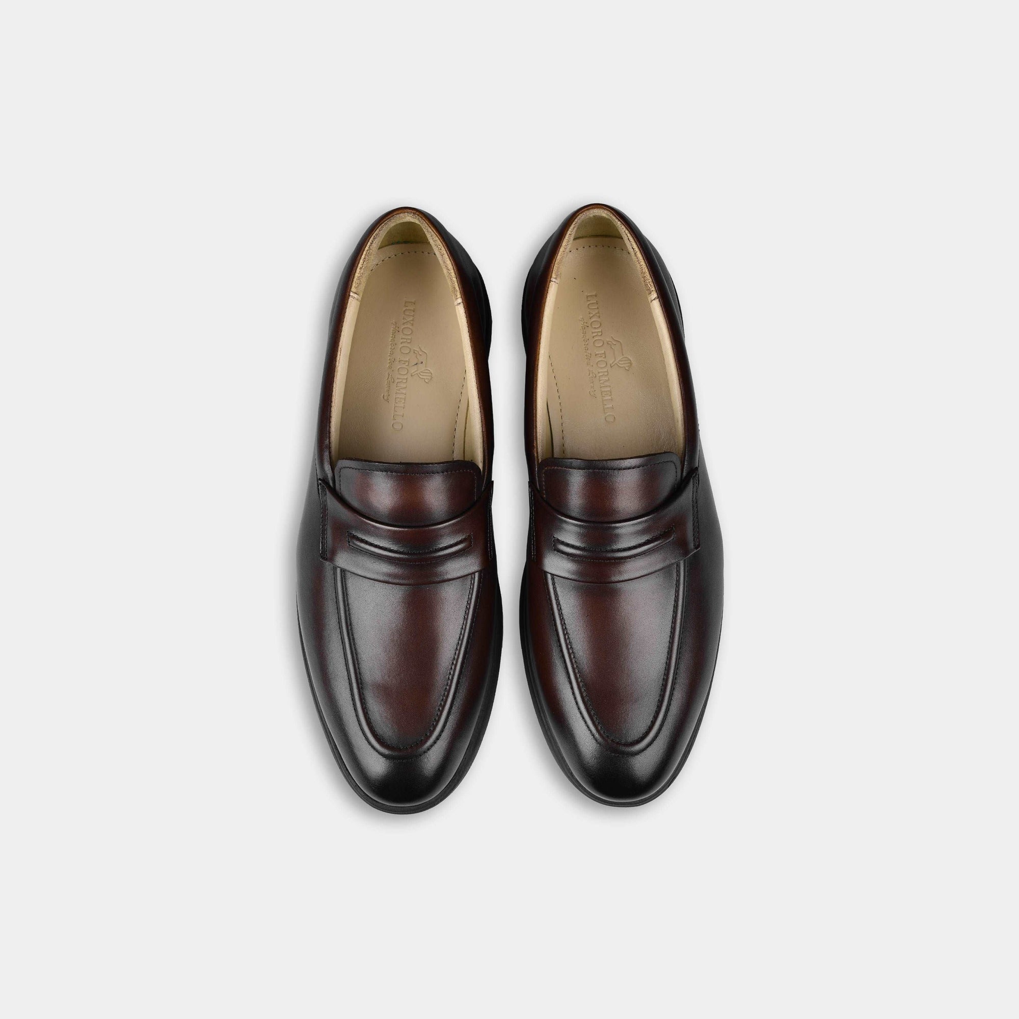 Pair of brown penny leather slip-on loafers by Aero-Flex, showcasing their sleek design and rich color.