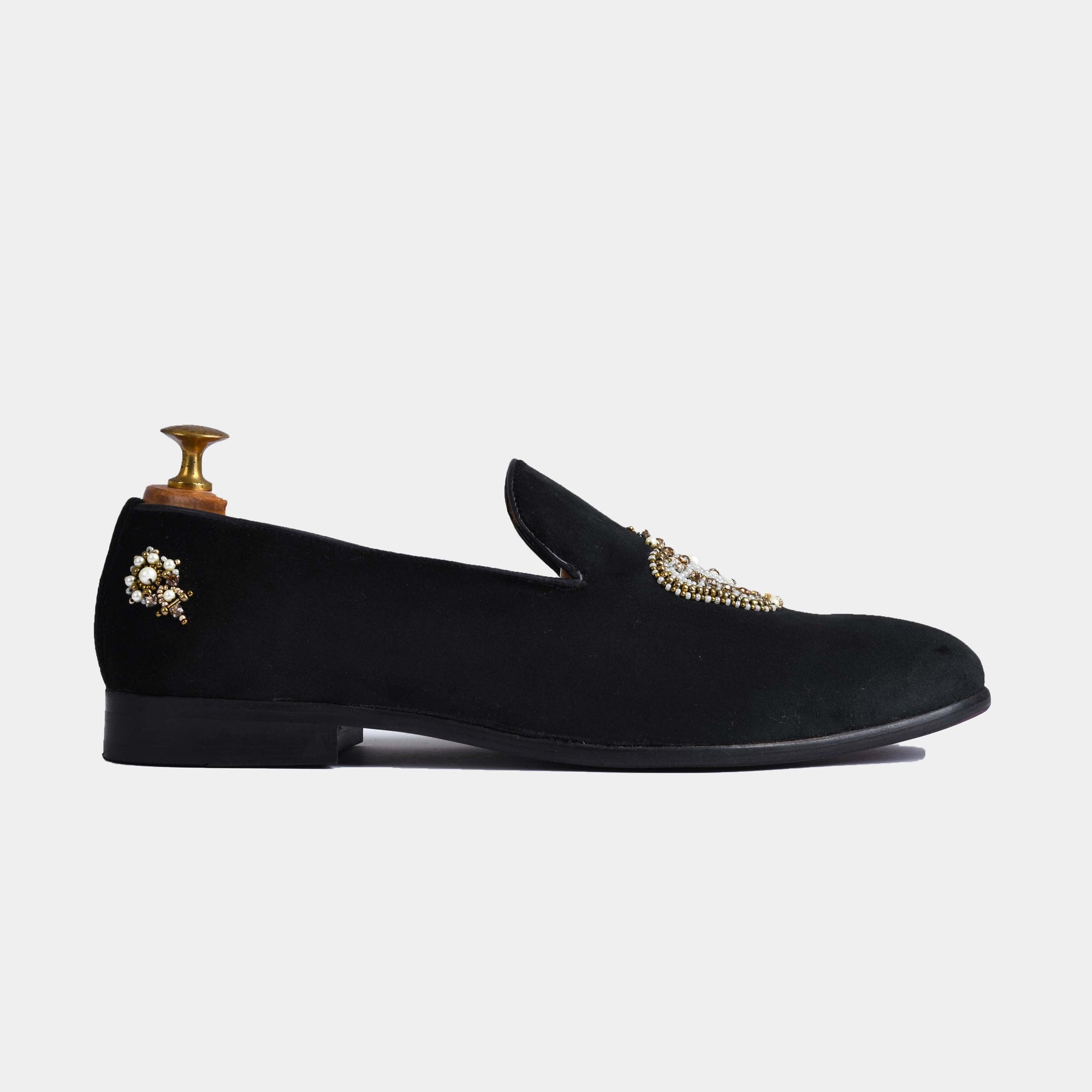 Pair of Elizar Black Embroidered Leather Slip-Ons with intricate gold and pearl embellishments on the vamp.