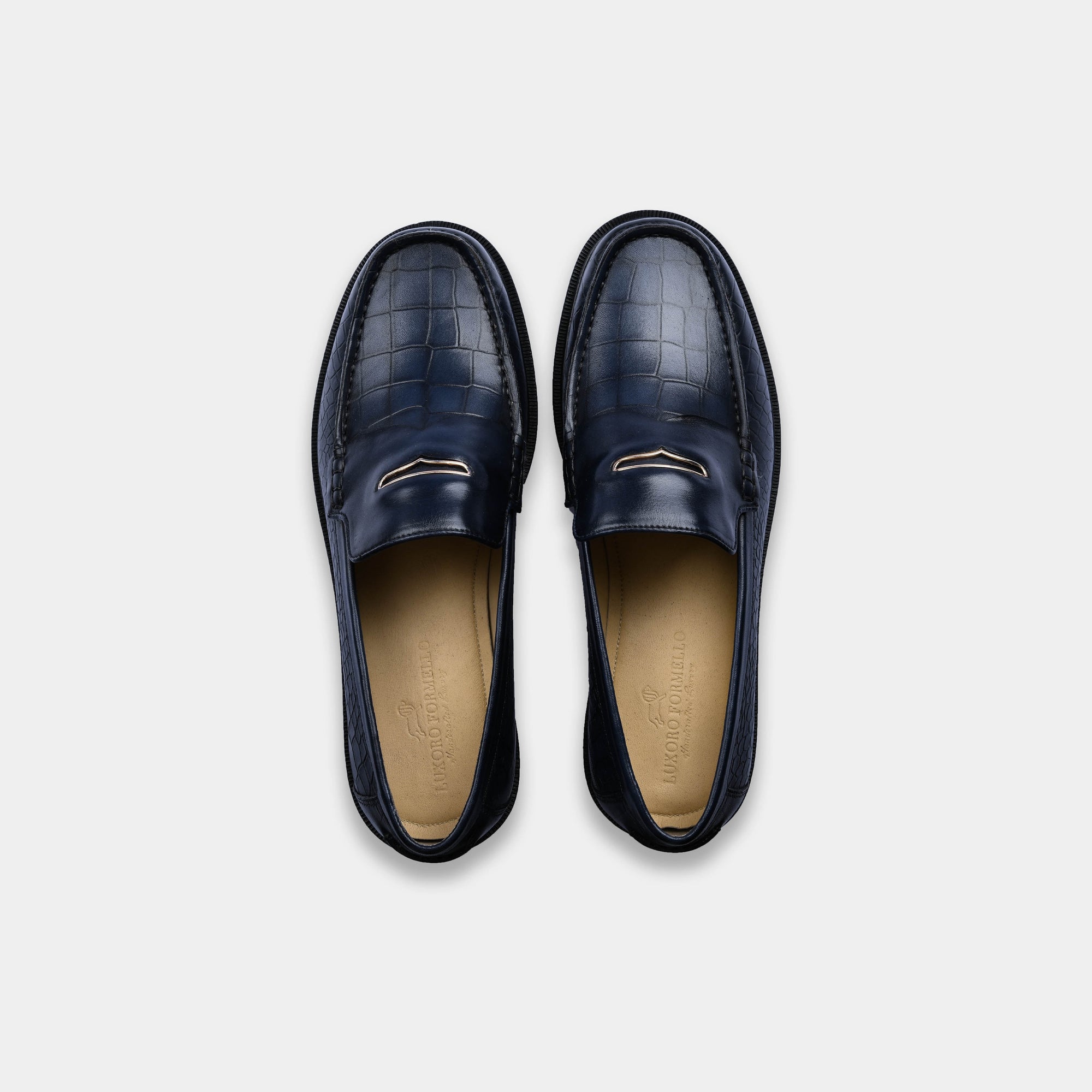 Pair of navy blue leather loafers with croc-embossed trim, viewed from above. Features Solesculpt Lite technology for comfort.