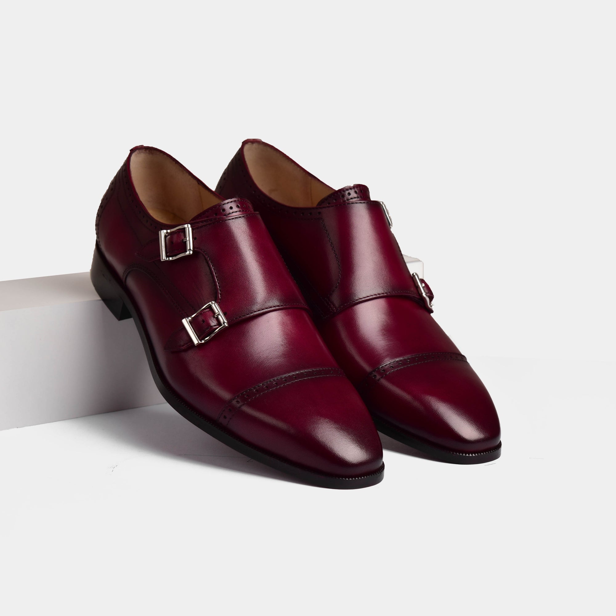 Pair of Tabor Ruby Leather Monk Straps shoes in burgundy leather with double monk strap closures.