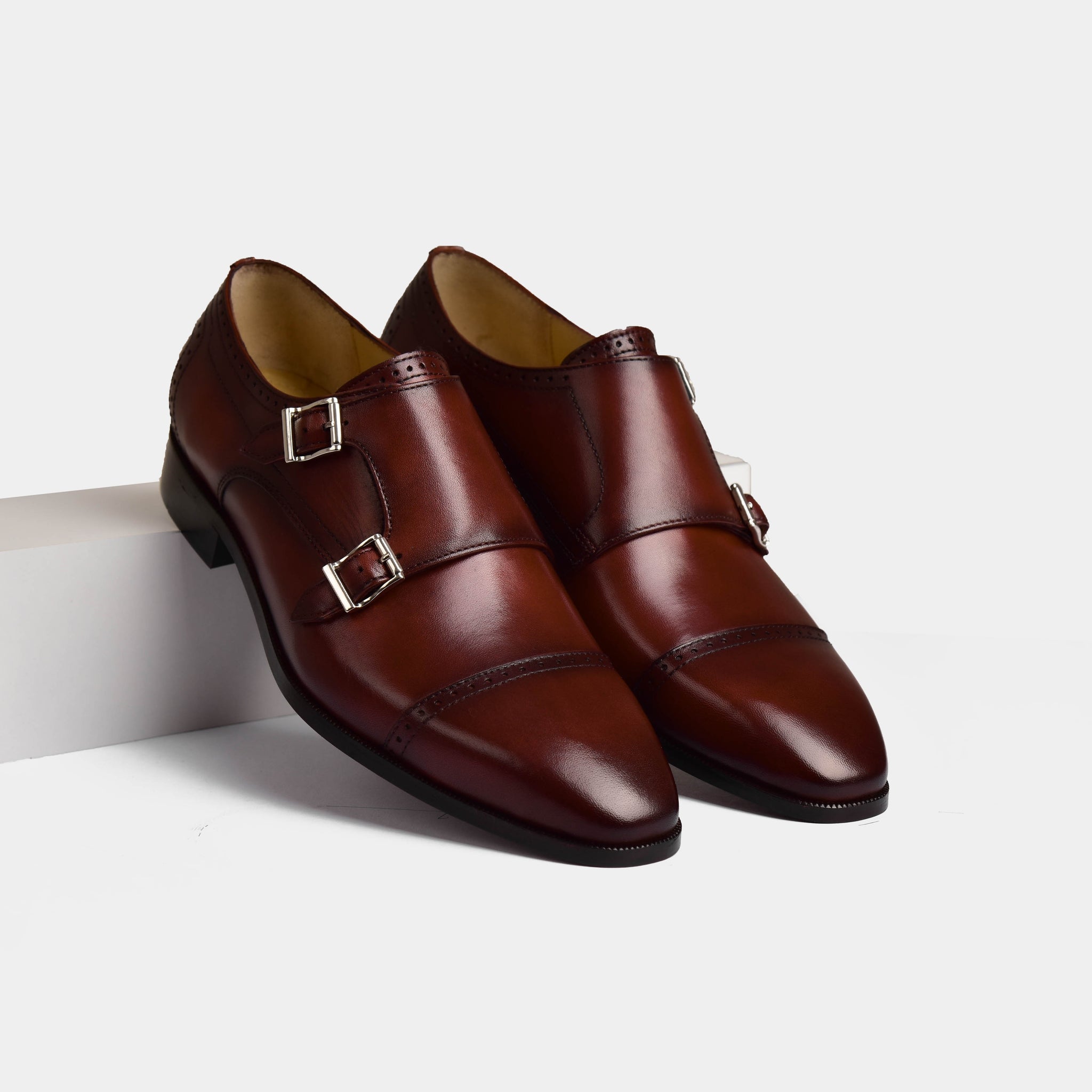 Viento Cognac Leather Monk Straps, featuring double monk straps and brogue detailing on polished cognac leather.