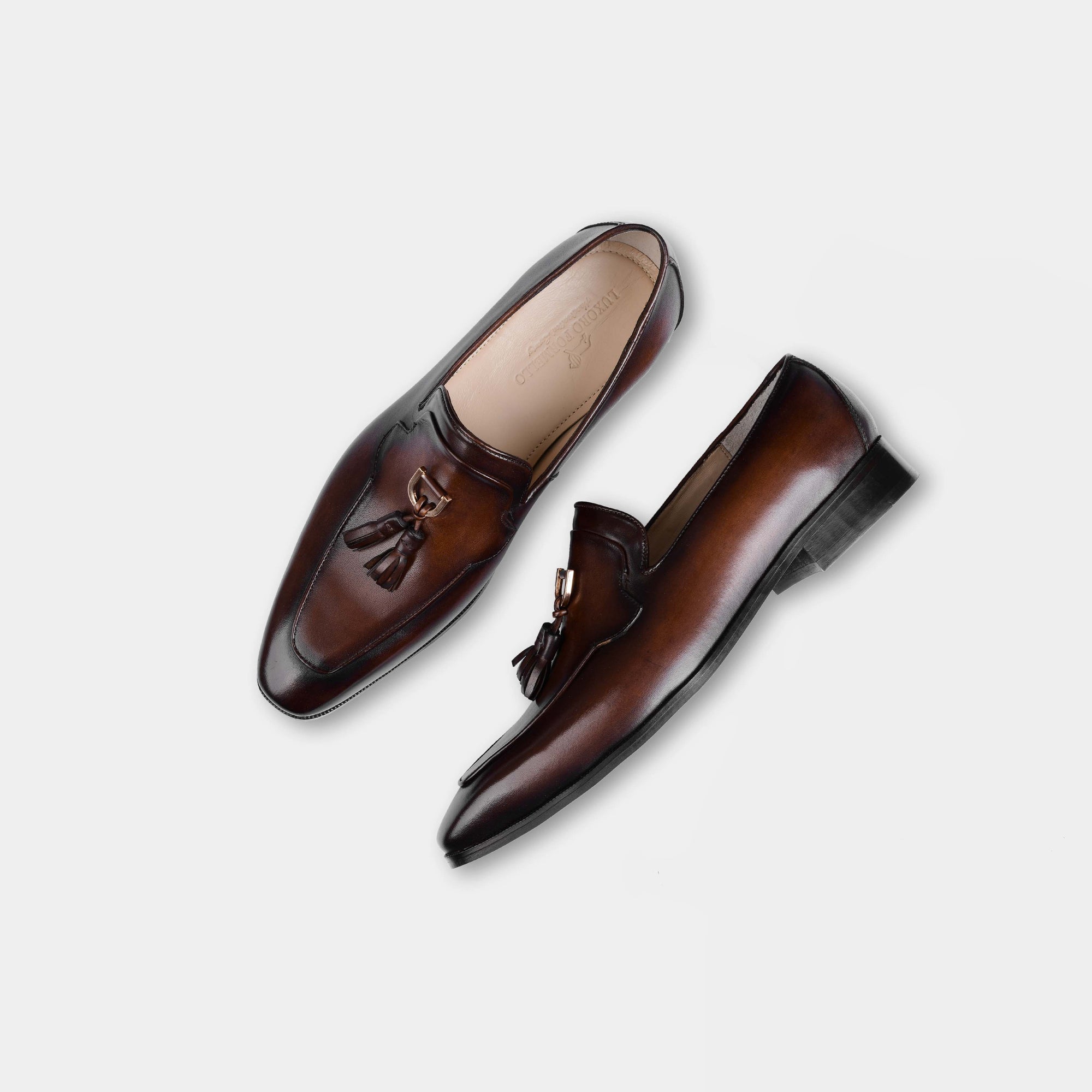 Pair of Atilio Brown Leather Loafers with decorative tassels, shot from above on a white background.