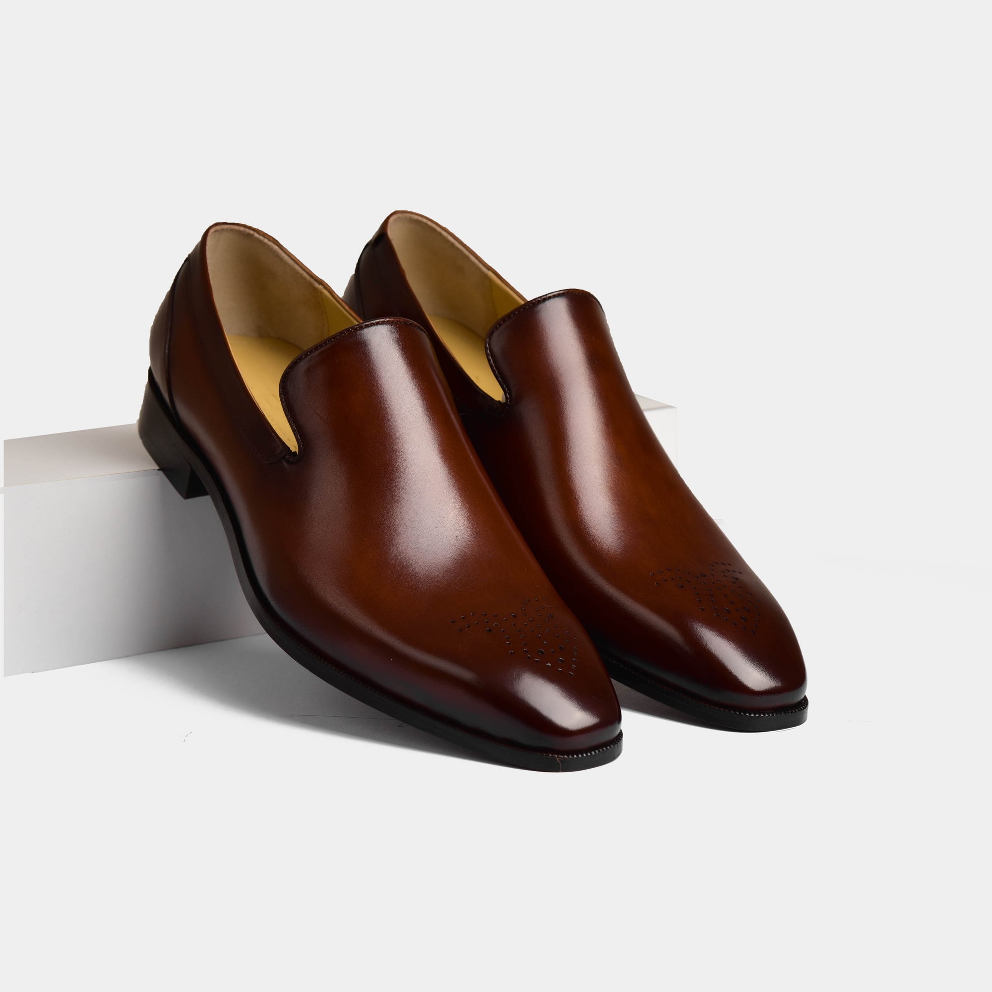 Pair of Charles Choc Leather Loafers, polished brown slip-on dress shoes with brogue detailing.