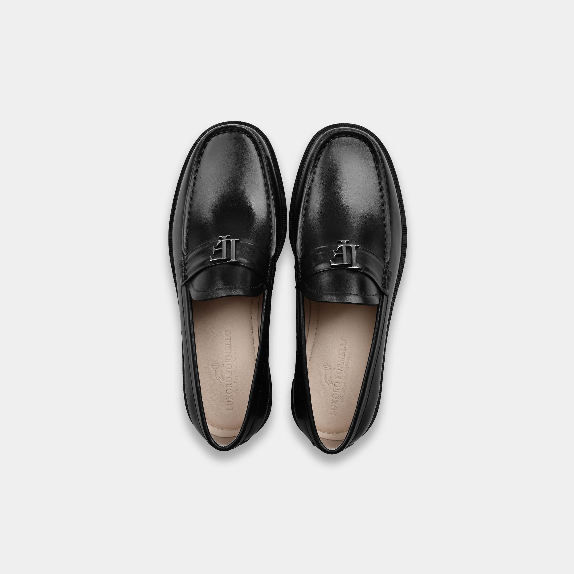 Pair of Black Lf Timeless Leather Loafers in black with silver buckle detail. Solesculpt Lite technology.