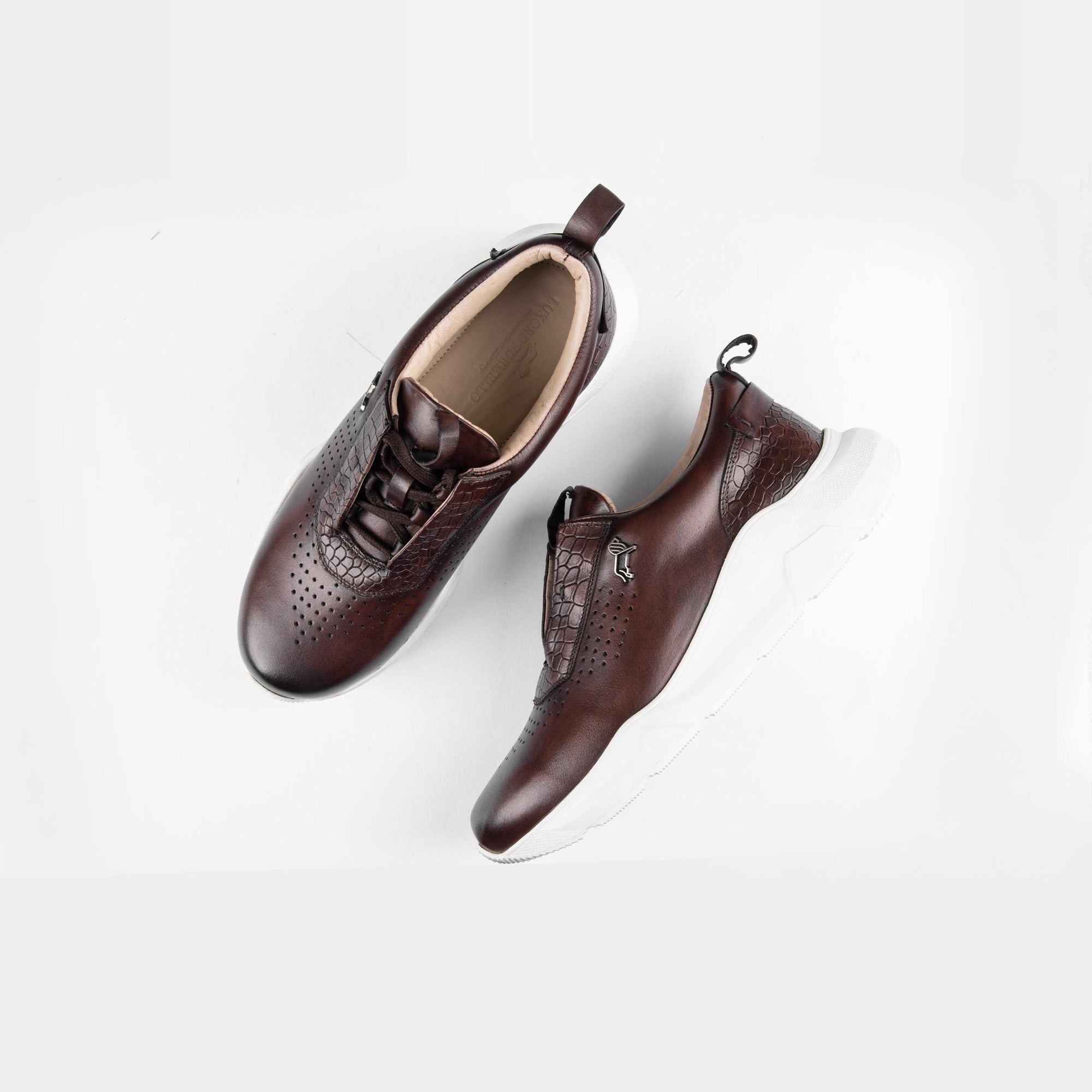 Pair of Arine brown leather sneakers for men with white soles and lace-up closure, styled on a white background.