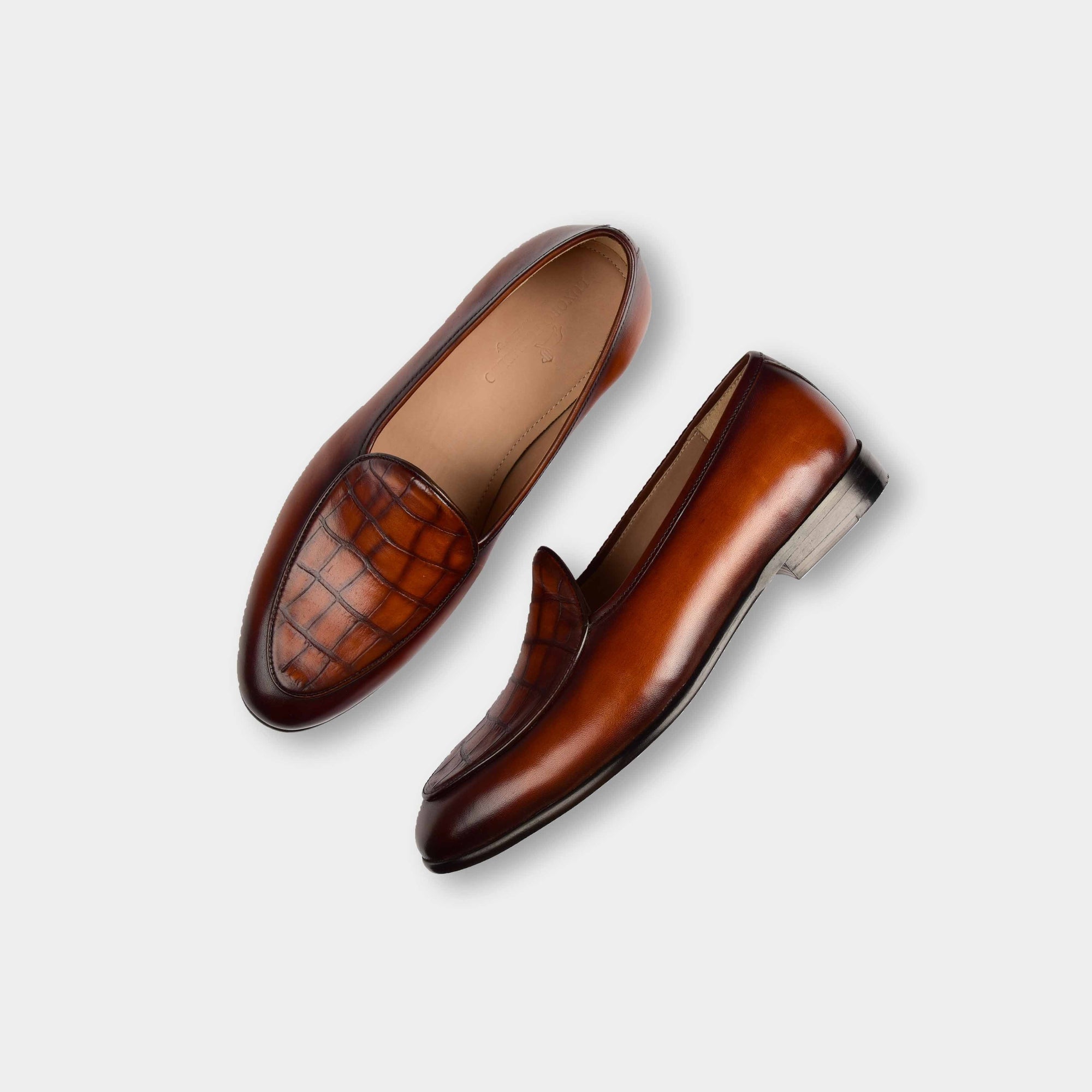 Pair of brown patina Arno Loafers with a textured vamp made from precious leather.