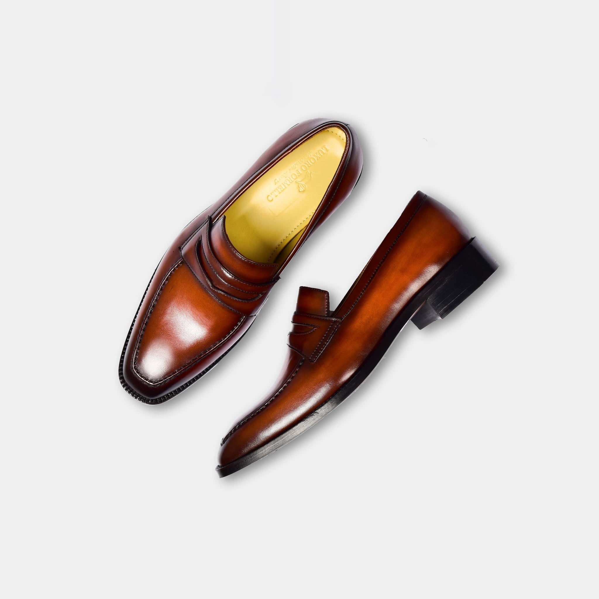 Pair of James Brown Leather Loafers in brown, showcasing their sleek design and polished finish.