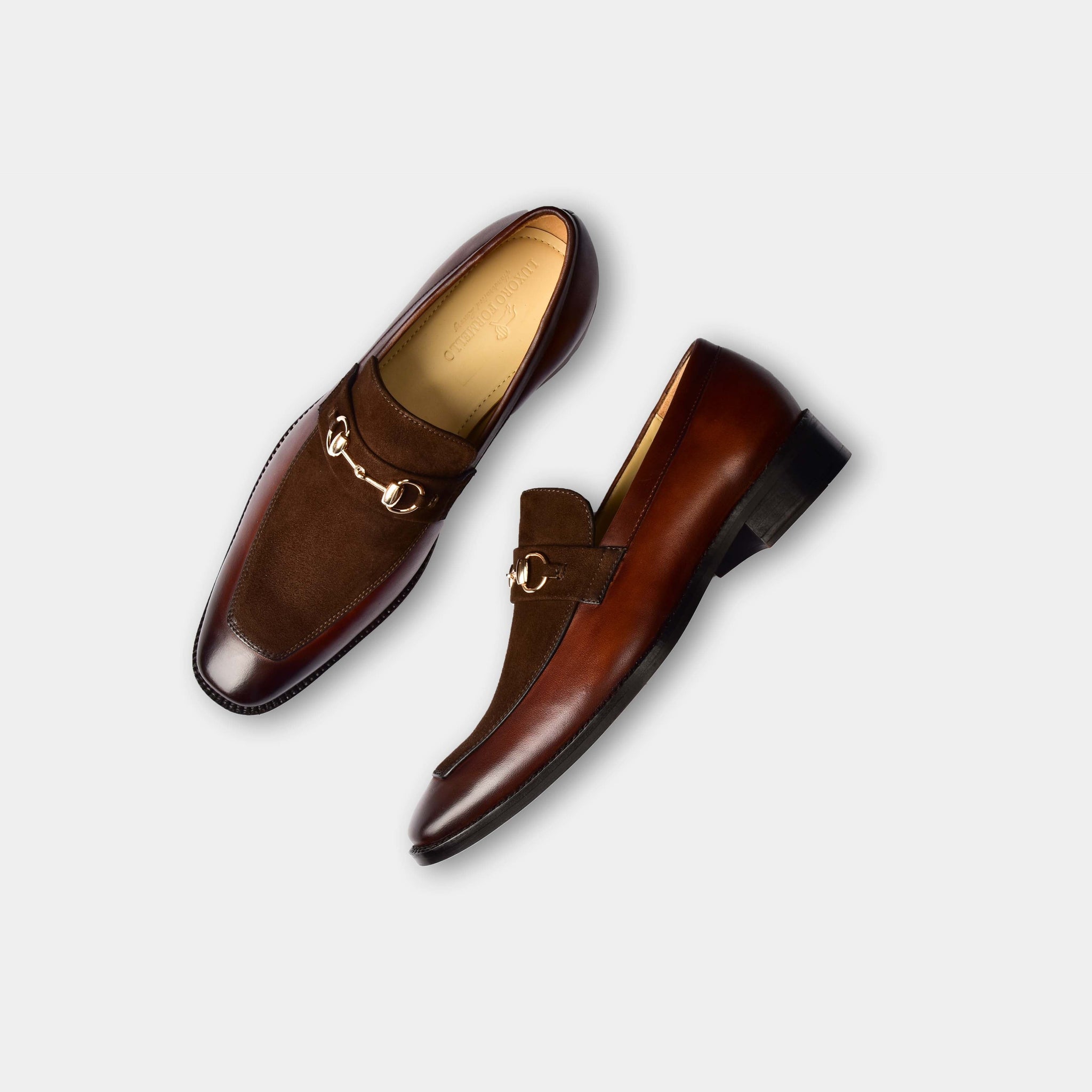 Pair of Mark Brown Leather Loafers with gold buckle detail, showcasing their stylish and sophisticated design.