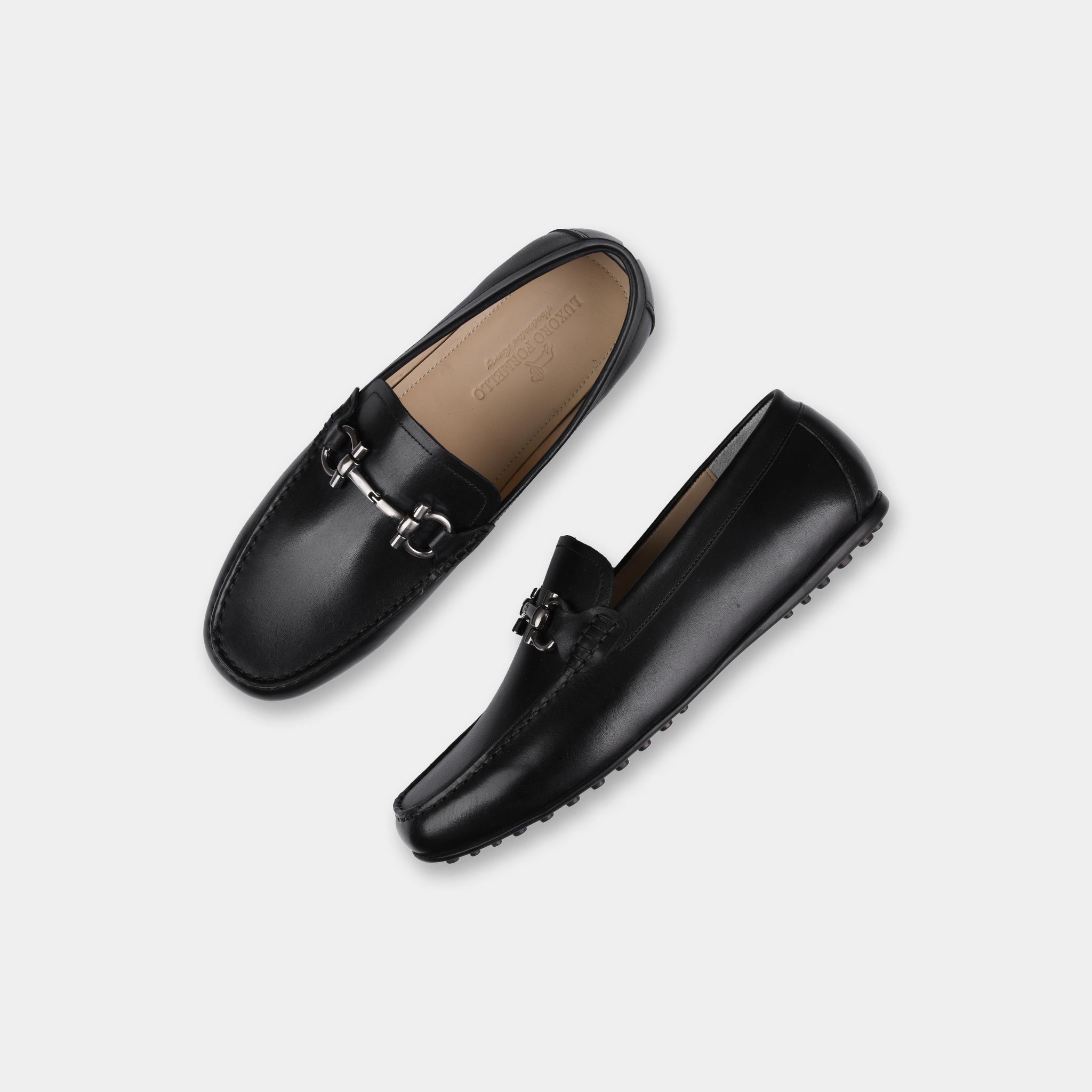 Pair of Helio Black Leather Driving Loafers with silver buckle detail.