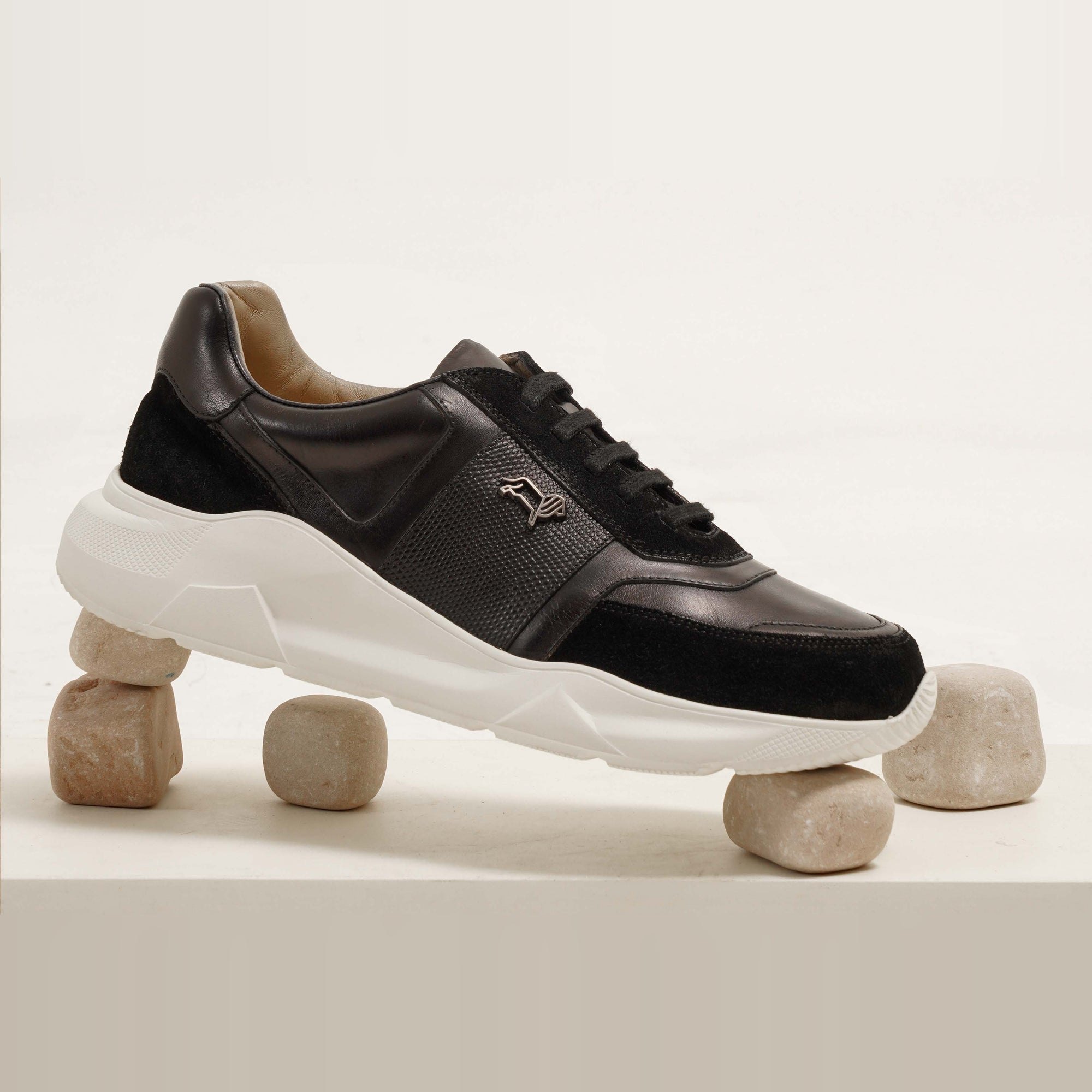 Aureo Black leather sneakers with a white sole. Stylish and modern design for men.