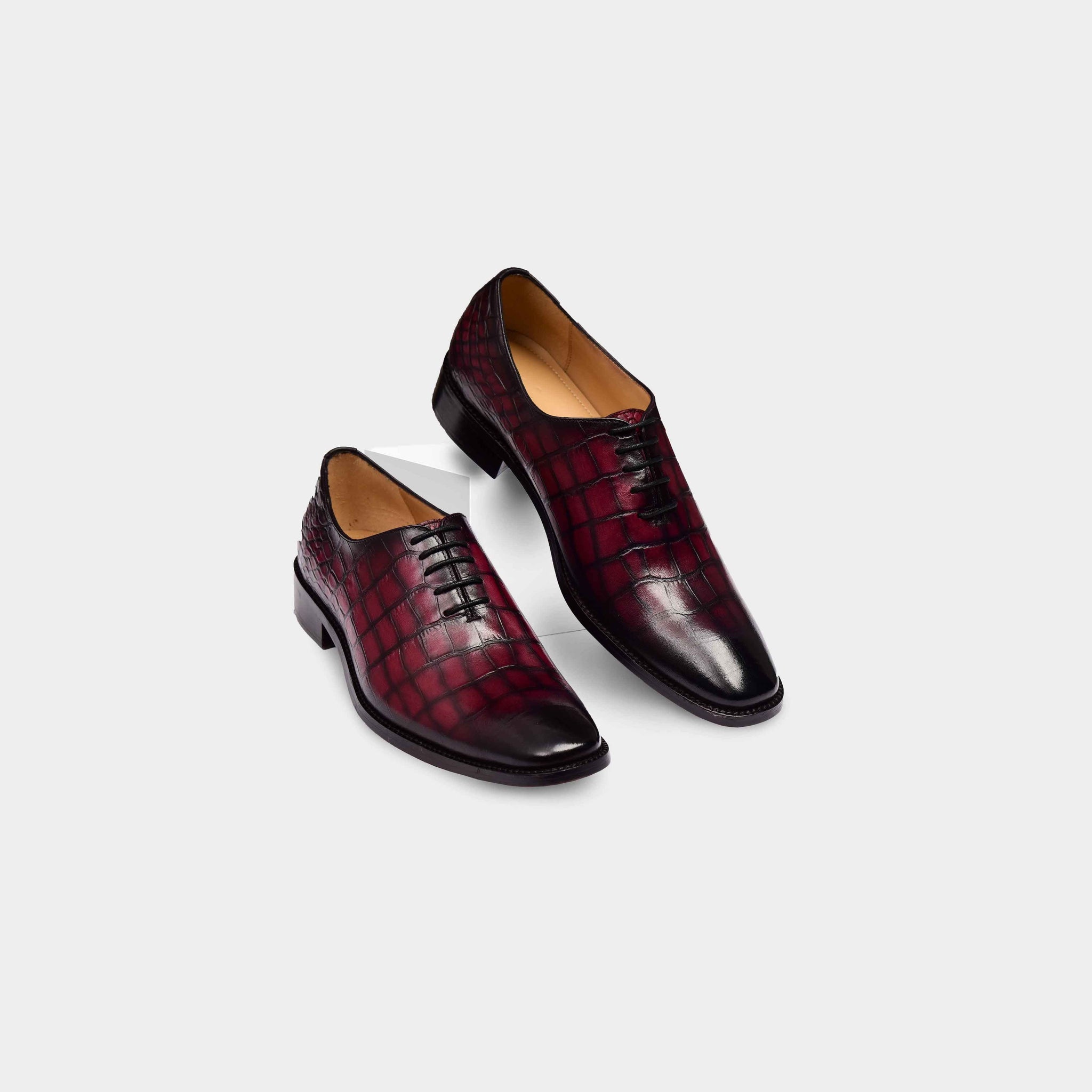 A pair of Winston Ruby Croc Lace Leather Laceups in burgundy crocodile-embossed leather.