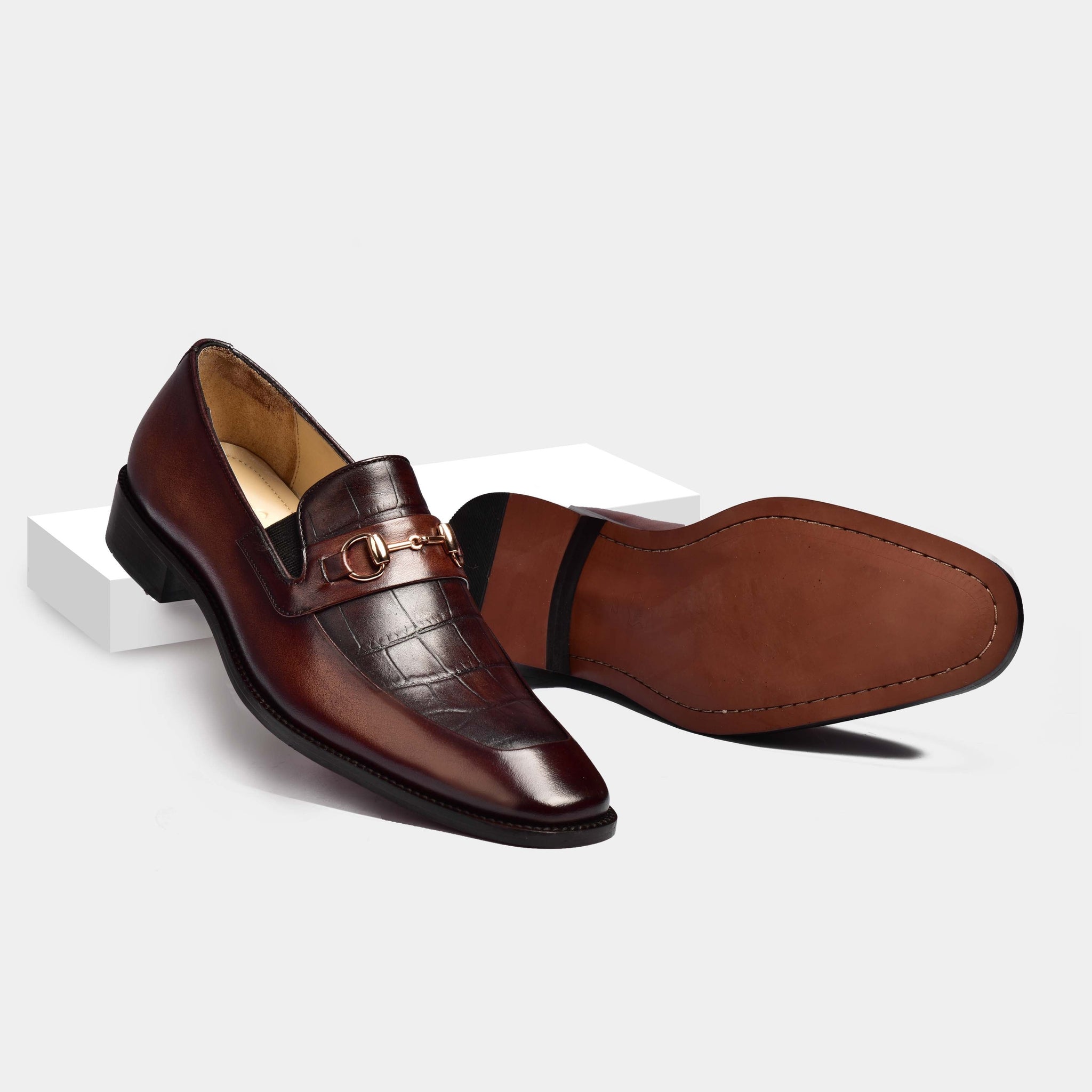 Pair of Sean Croc Brown Leather Loafers, one upright with gold buckle detail, showcasing the croc-embossed leather.