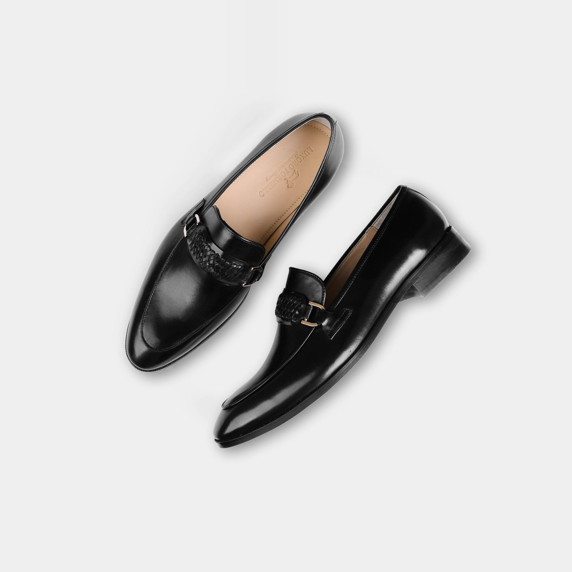 Pair of Cesar Black Leather Loafers with a woven leather strap and gold buckle detail.