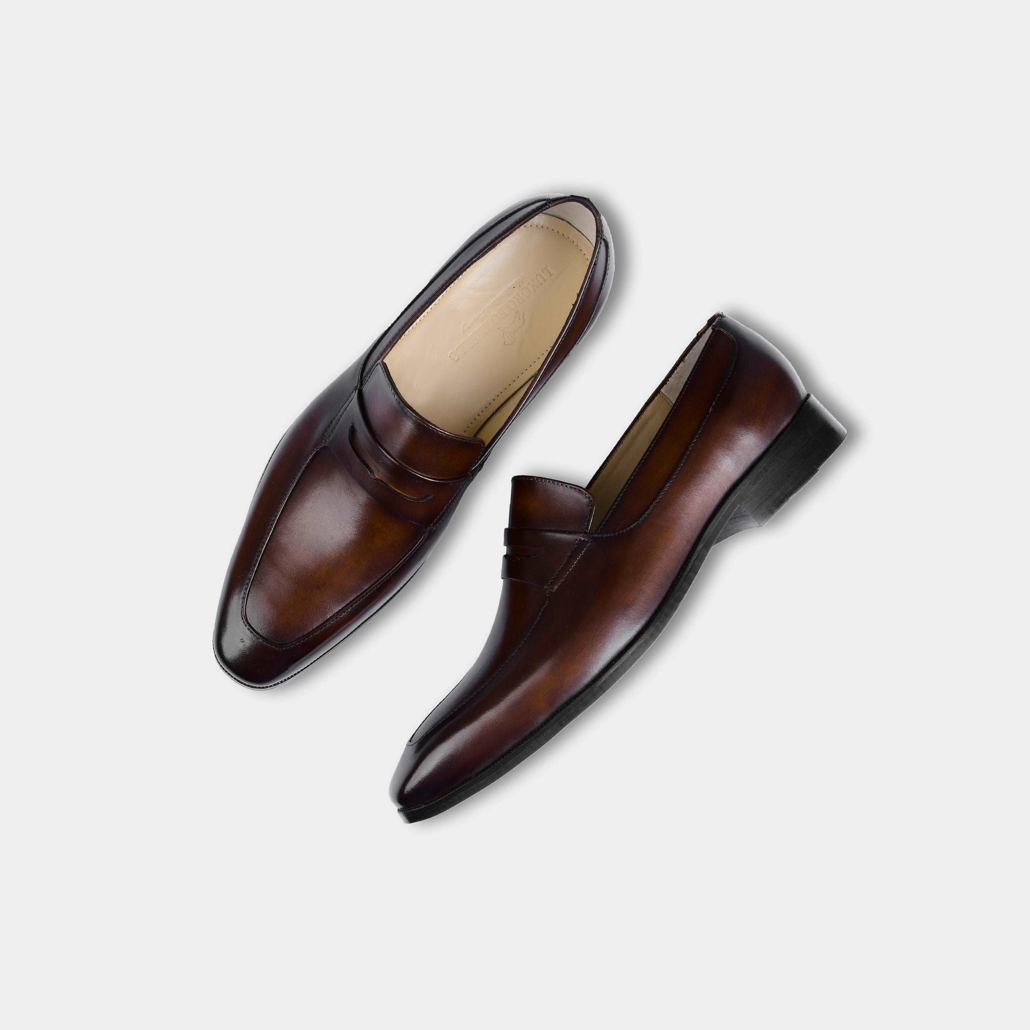 Pair of Andres Brown Loafers in burnished brown leather, showcasing the classic penny loafer design.