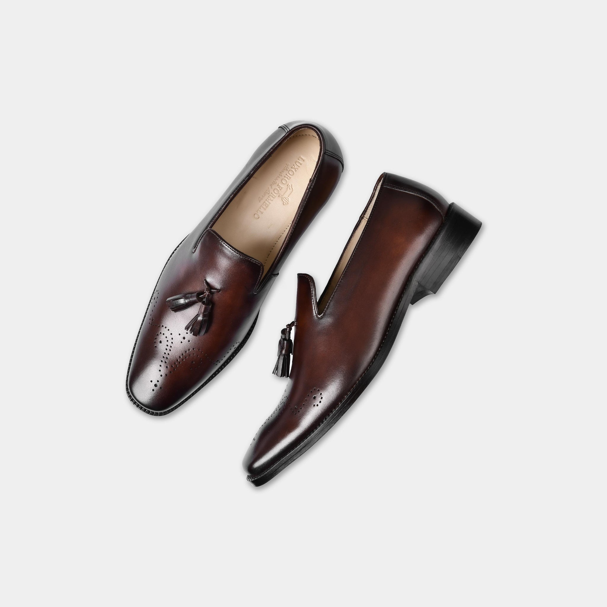 Pair of Vincenz Brown Leather Loafers with tassels, showcasing their brown leather construction and perforated detailing.