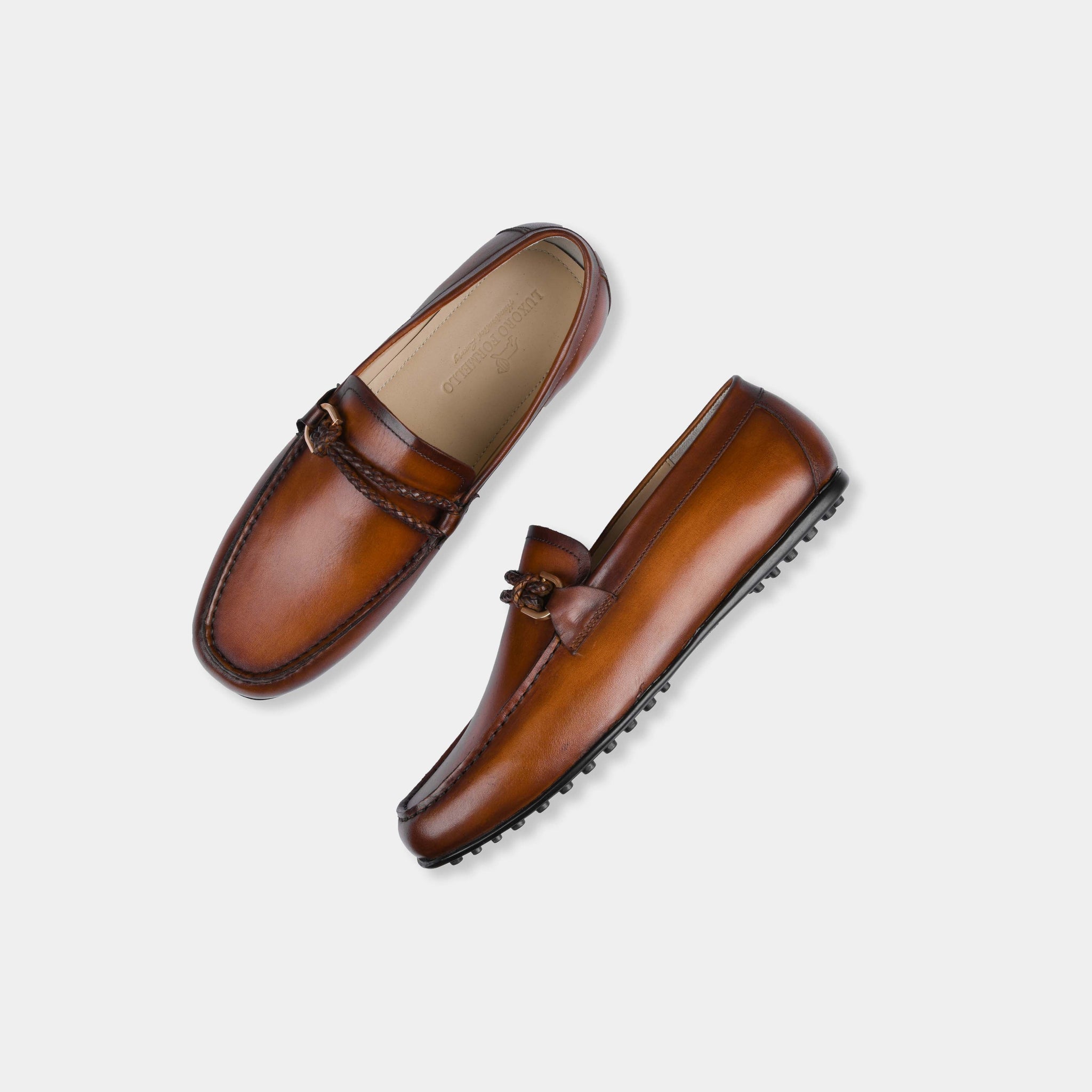 Pair of Pablo Tan Leather Driving Loafers in tan leather with a braided strap and metal accent.