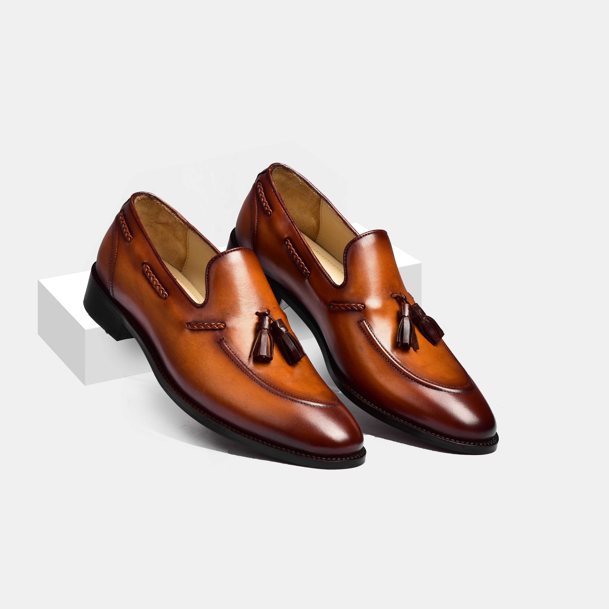 A pair of brown Wilson Miller Leather Loafers with decorative tassels, showcasing their stylish design and premium leather construction.