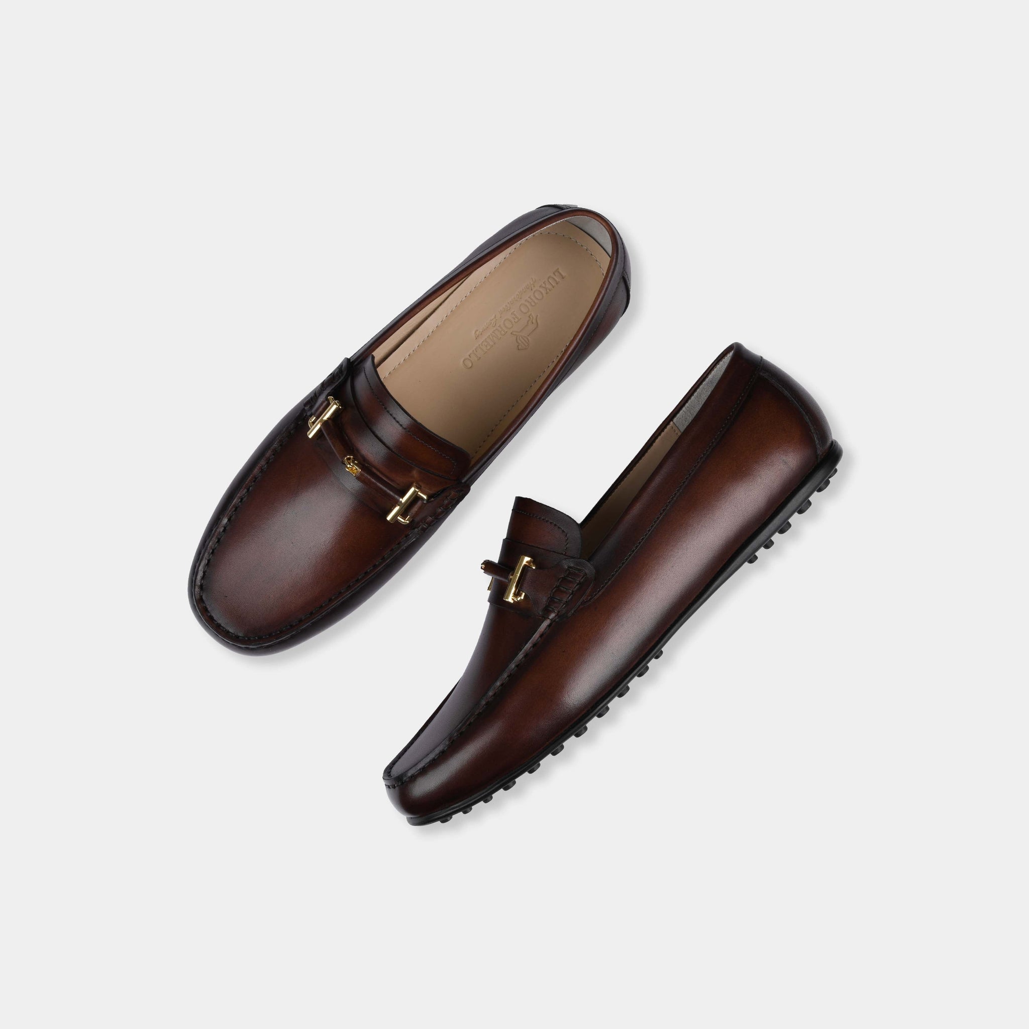 Pair of Diablo Brown Leather Driving Loafers with gold buckle detail, shown from above on a white background.