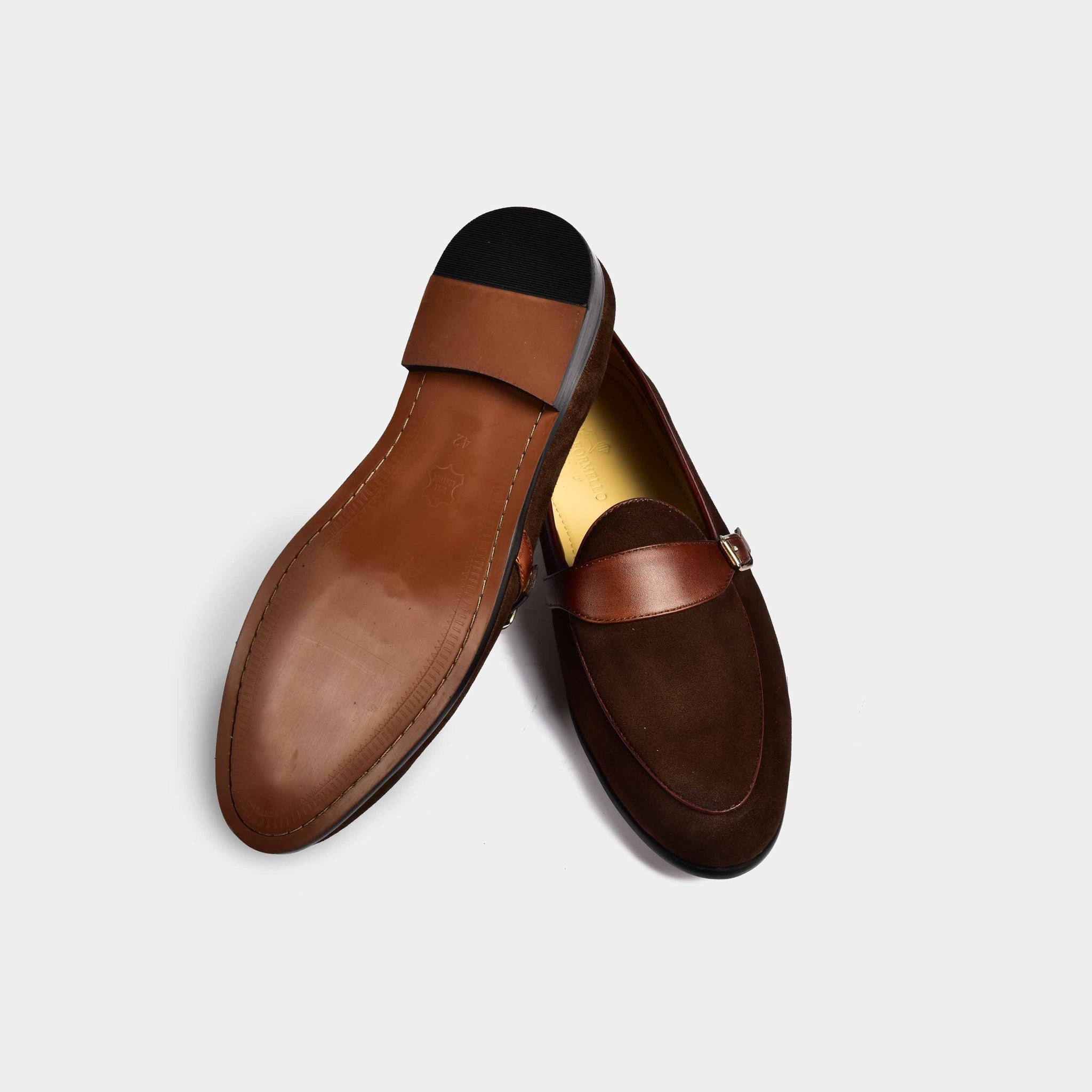 Pair of brown suede Arno Loafers with a stylish buckle strap across the front.