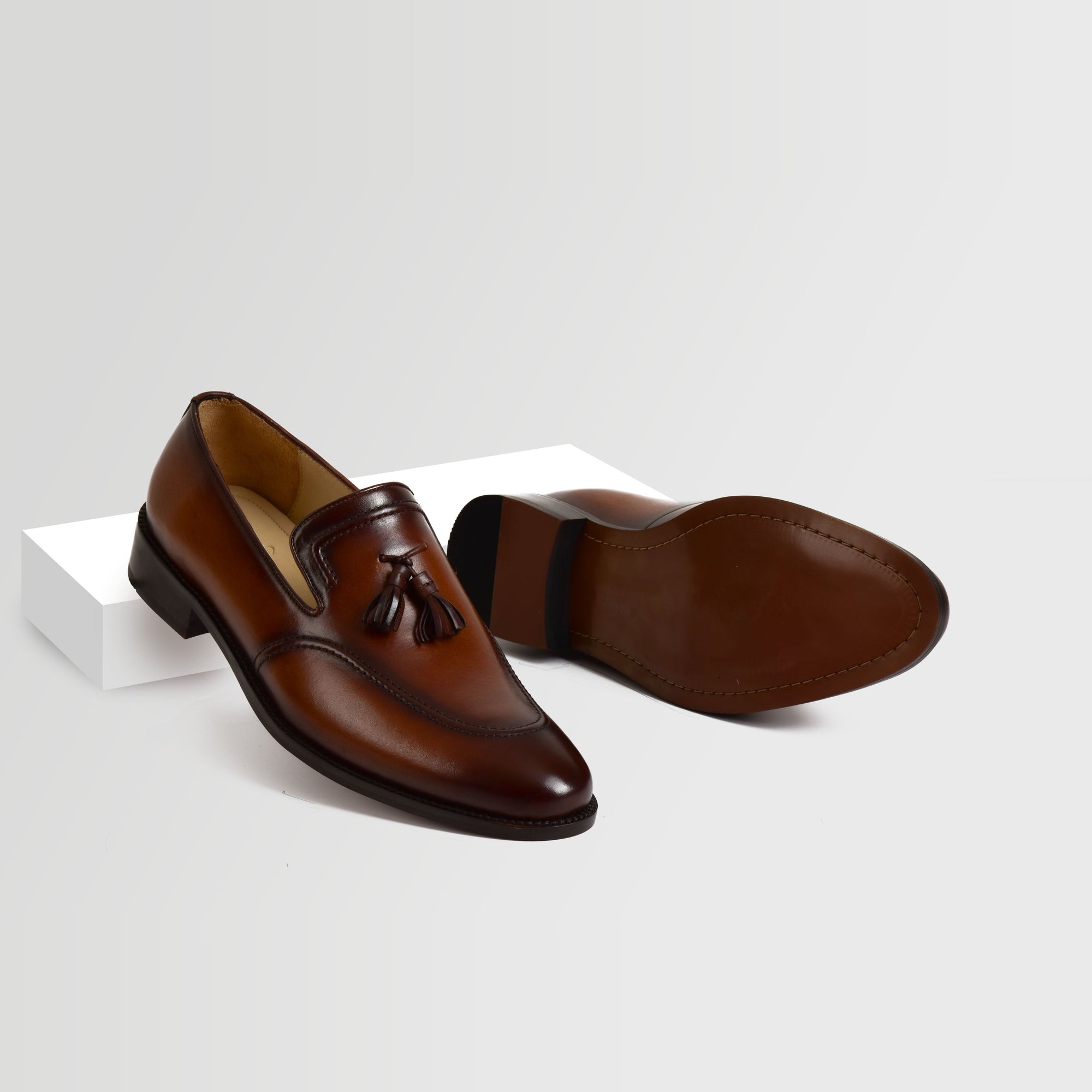 Pair of Jim Taylor Leather Loafers in brown, featuring a classic tassel design.