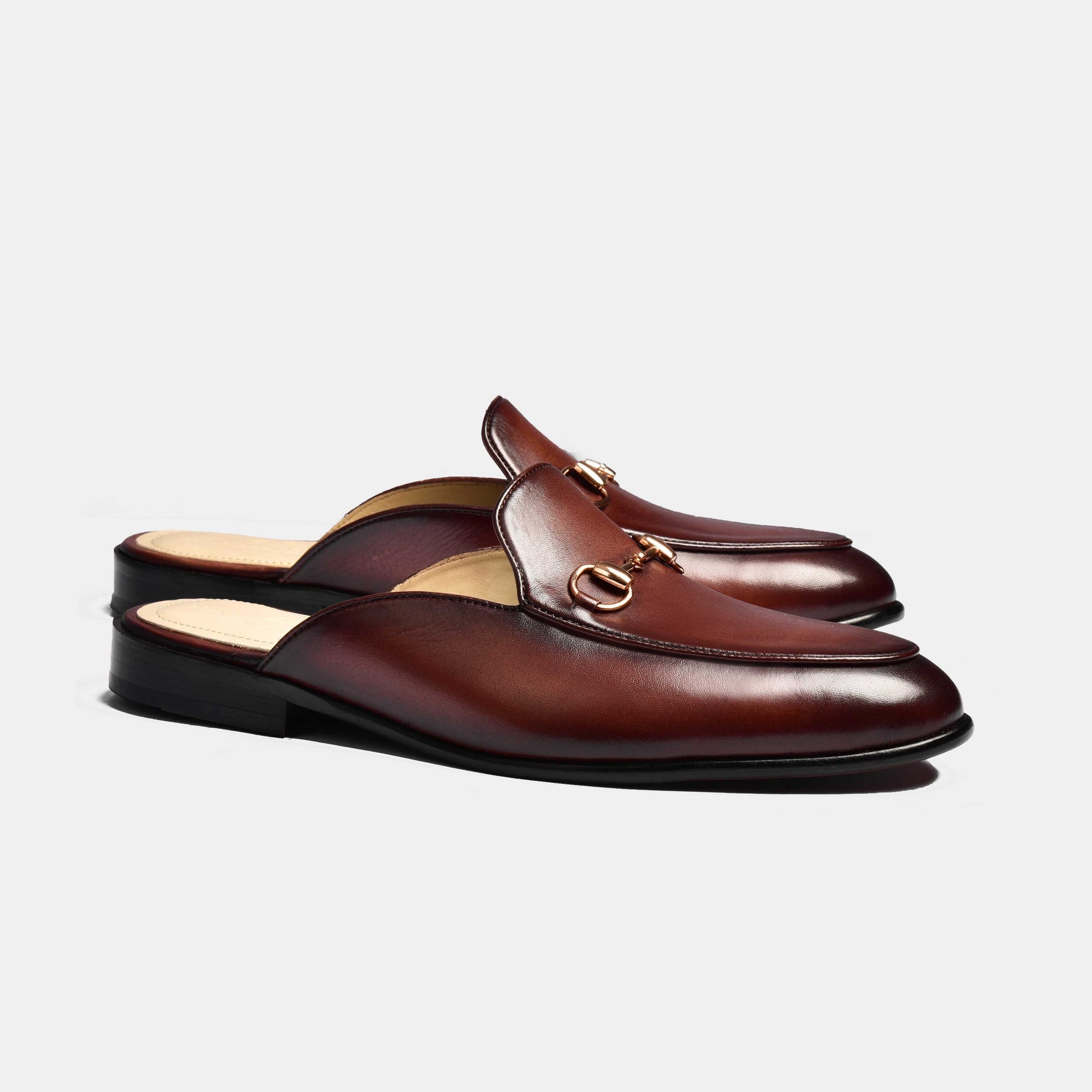 A pair of Arno Brown Formal Leather Mules with gold metal trim detail.