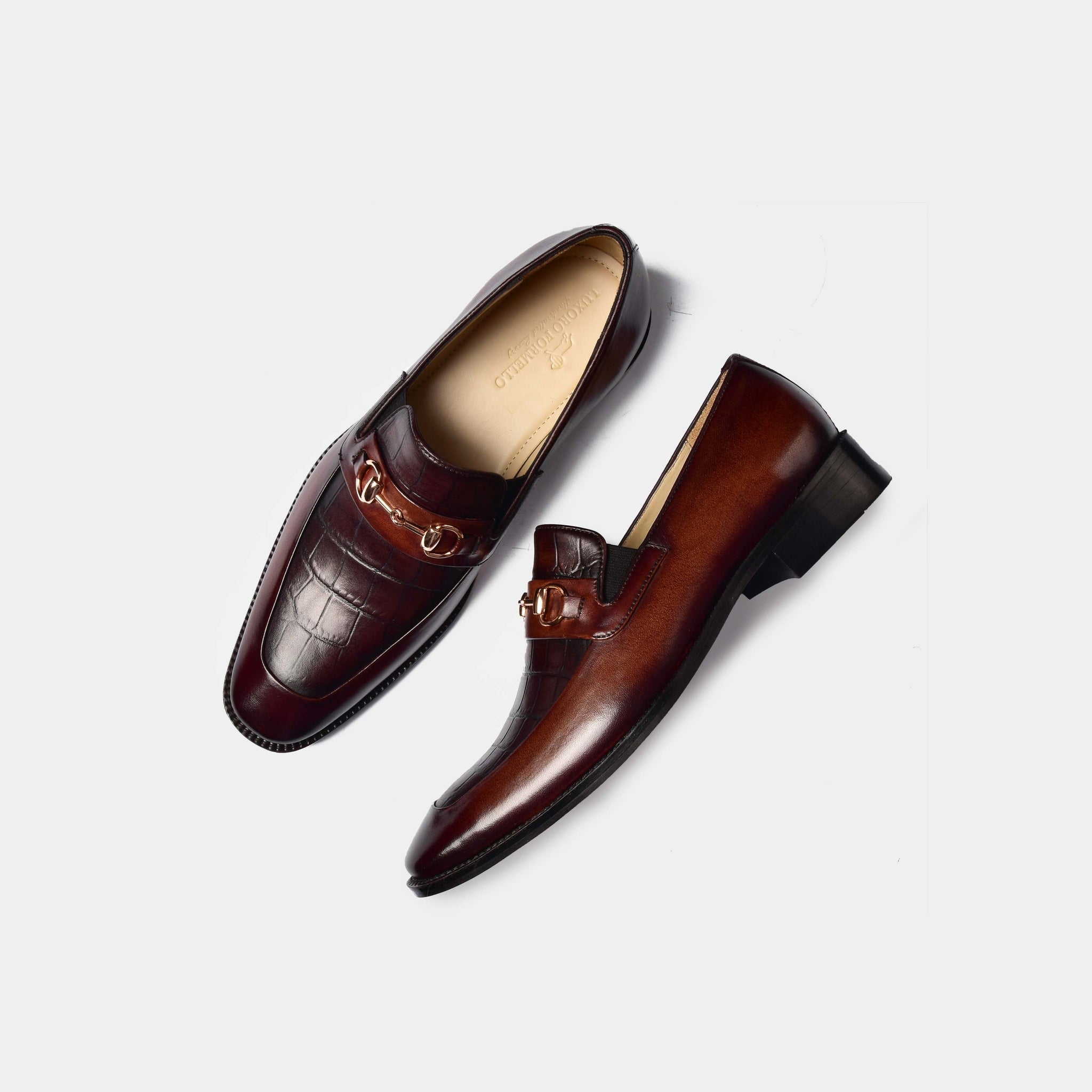 Pair of Sean Croc Brown Leather Loafers with gold buckle detail, shown from above on a white background.