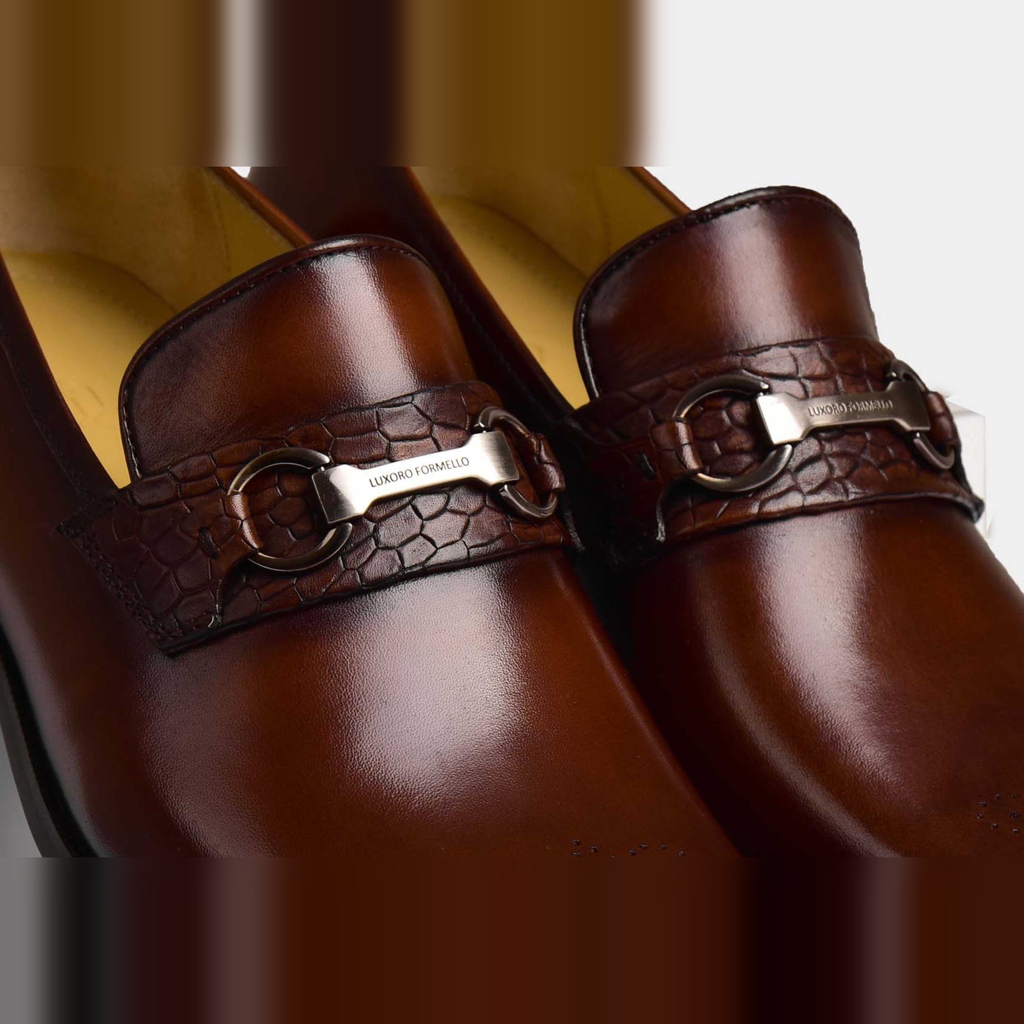 A pair of Diaz Choc Loafers in polished brown leather, featuring a textured strap and silver-tone buckle detail.